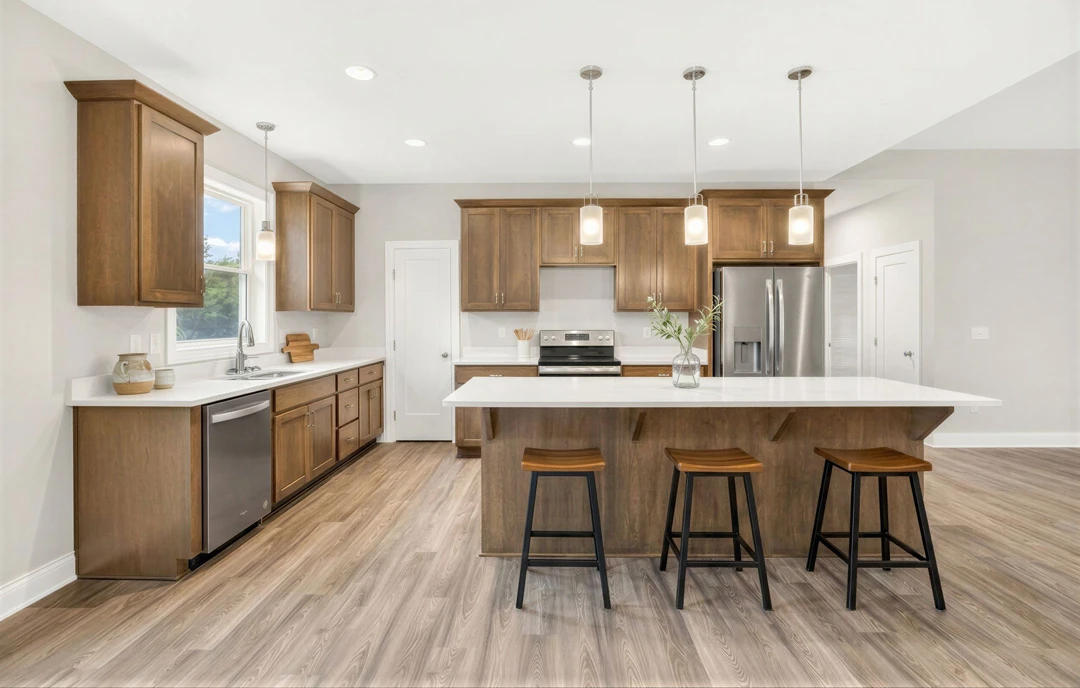 Kitchen with a large island featuring a granite countertop, black metal stools with wooden seats, stainless steel refrigerator, light wood cabinetry, hardwood flooring, and a vase