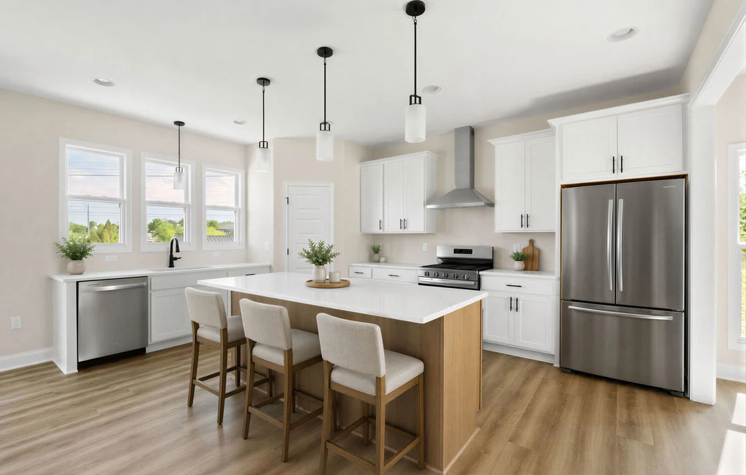 Kitchen with a large central island featuring granite countertops, white cabinetry, stainless steel refrigerator and dishwasher, laminate flooring, and chairs at the island.