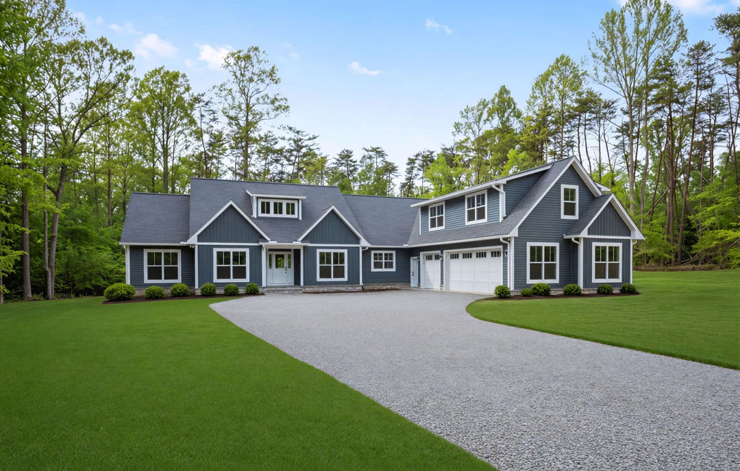 Two-story house with white trim, a white door with glass windows, attached garage, and a concrete driveway bordered by green lawn and mature trees.