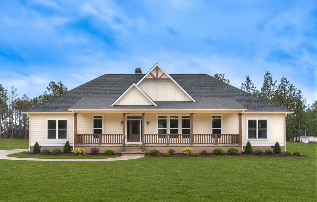 Two-story farmhouse-style home with white siding, a triangular roof, and a covered porch featuring a white door with a glass panel, set on a green lawn with a concrete walkway and