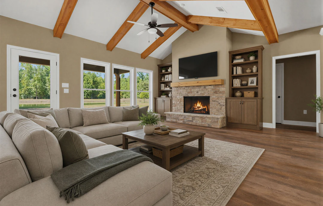 Living room with hardwood flooring, a gray couch draped with a blanket, a coffee table holding a potted plant, a fireplace, a wall-mounted black TV, and a ceiling fan overhead.