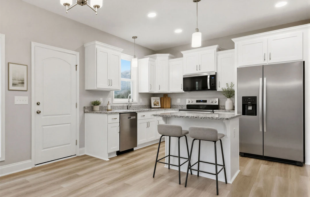 Kitchen with white cabinets, granite countertops, stainless steel appliances including a refrigerator and microwave, bar stools with cushions at the island, and light-colored