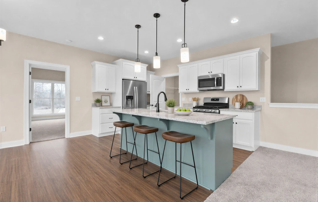 Kitchen with white cabinets, granite countertops, a silver refrigerator, an open microwave, a large window, and a wood-seat bar stool on laminate wood flooring.