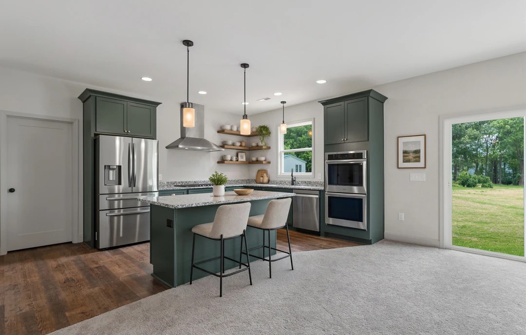 Kitchen with white cabinetry, granite countertops, a central island with two black-framed chairs, stainless steel refrigerator with water dispenser, built-in microwave, and light