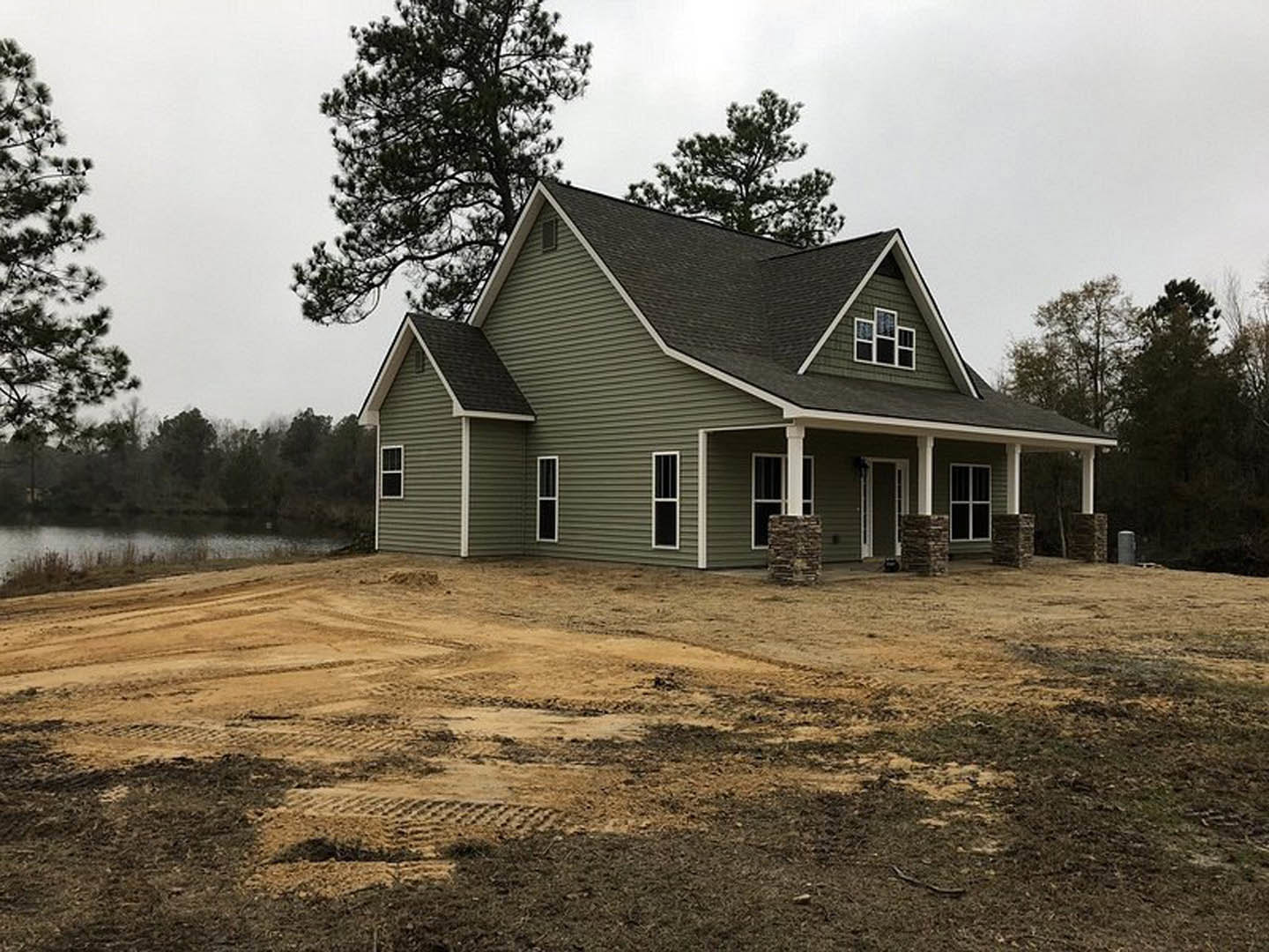 A house under construction with Little White House and trees.