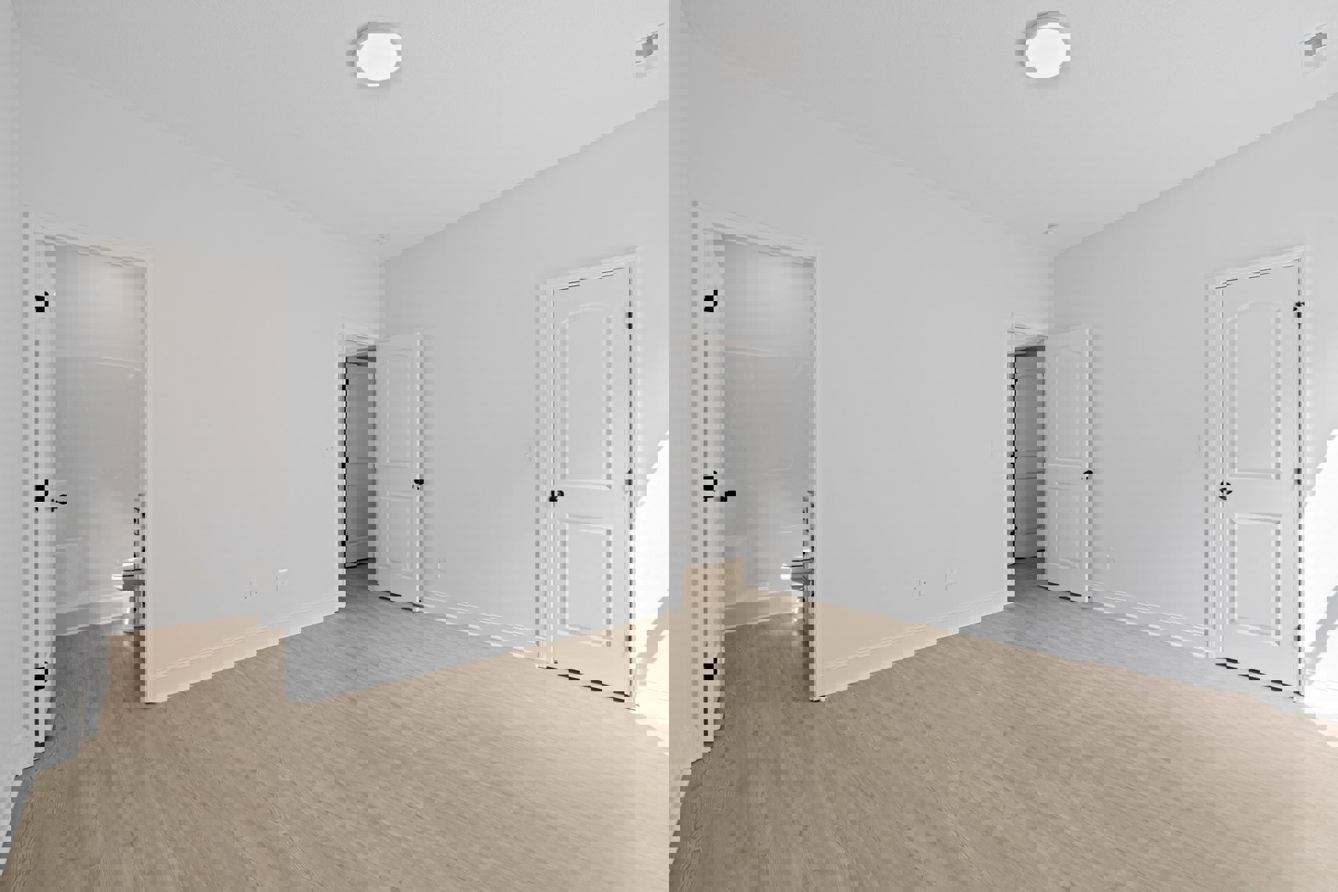 White walls and wood flooring in a room featuring a white door with black handle, ceiling vent, and white ceiling light fixture.