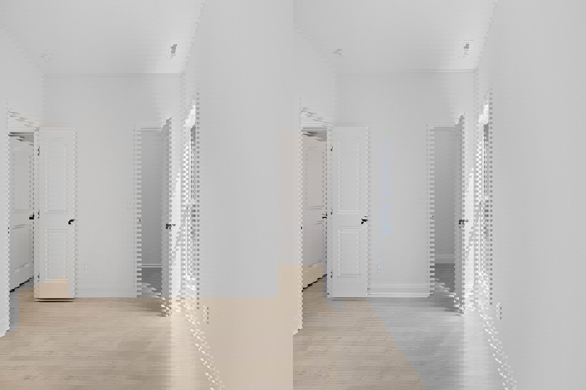 White walls, wood flooring, white door with black knob, ceiling vent, window with white frame