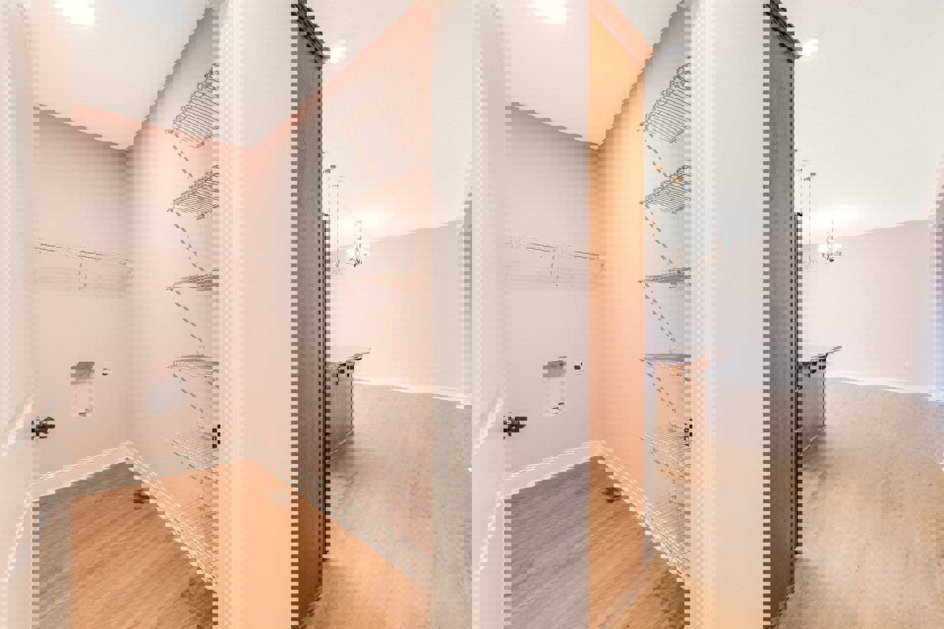 Pink walls with built-in white shelves, wood floor with vent, black refrigerator, white wall opening, four-light ceiling fixture