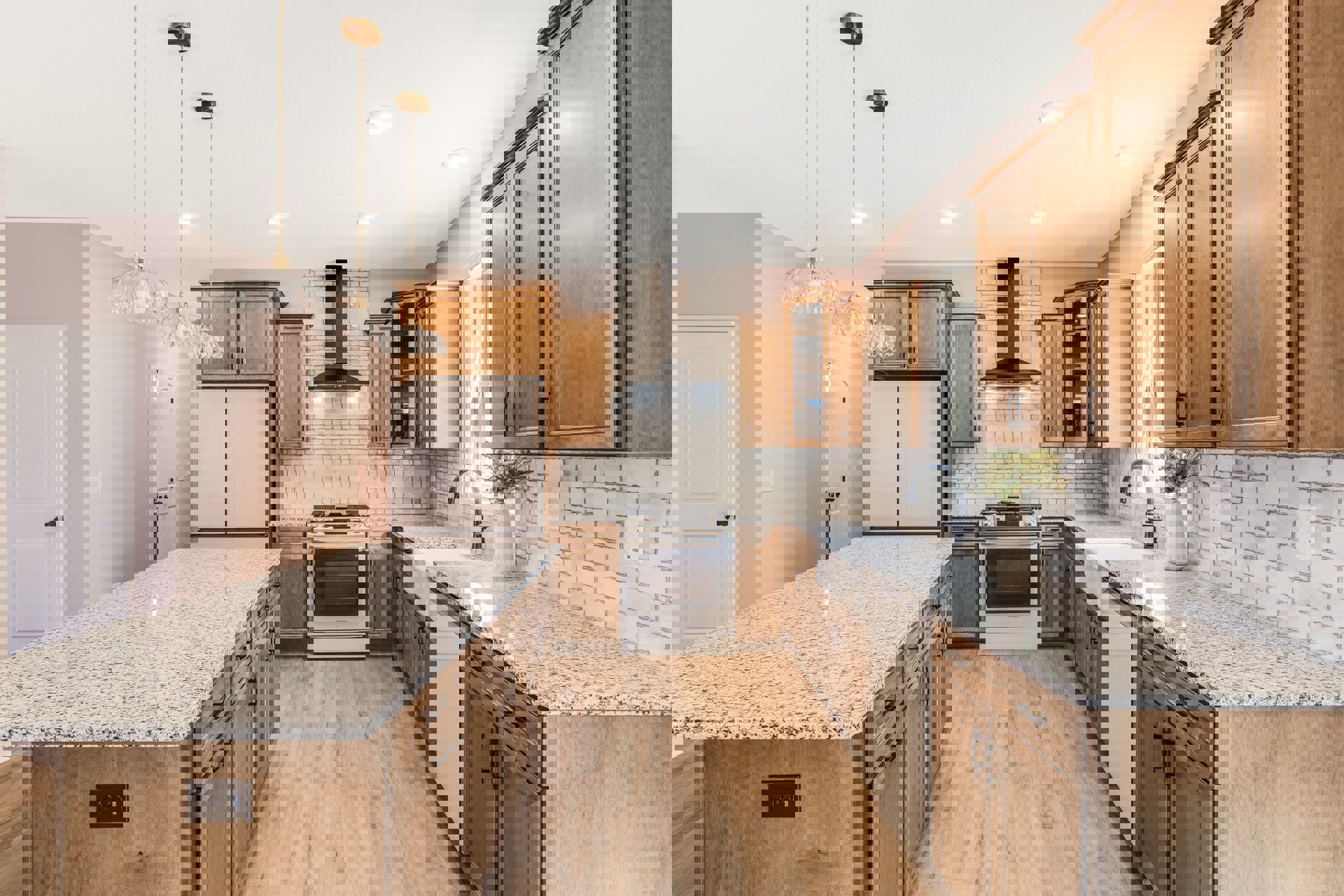 Marble kitchen island with vase of flowers, white cabinetry, black stove, and white door with black knob