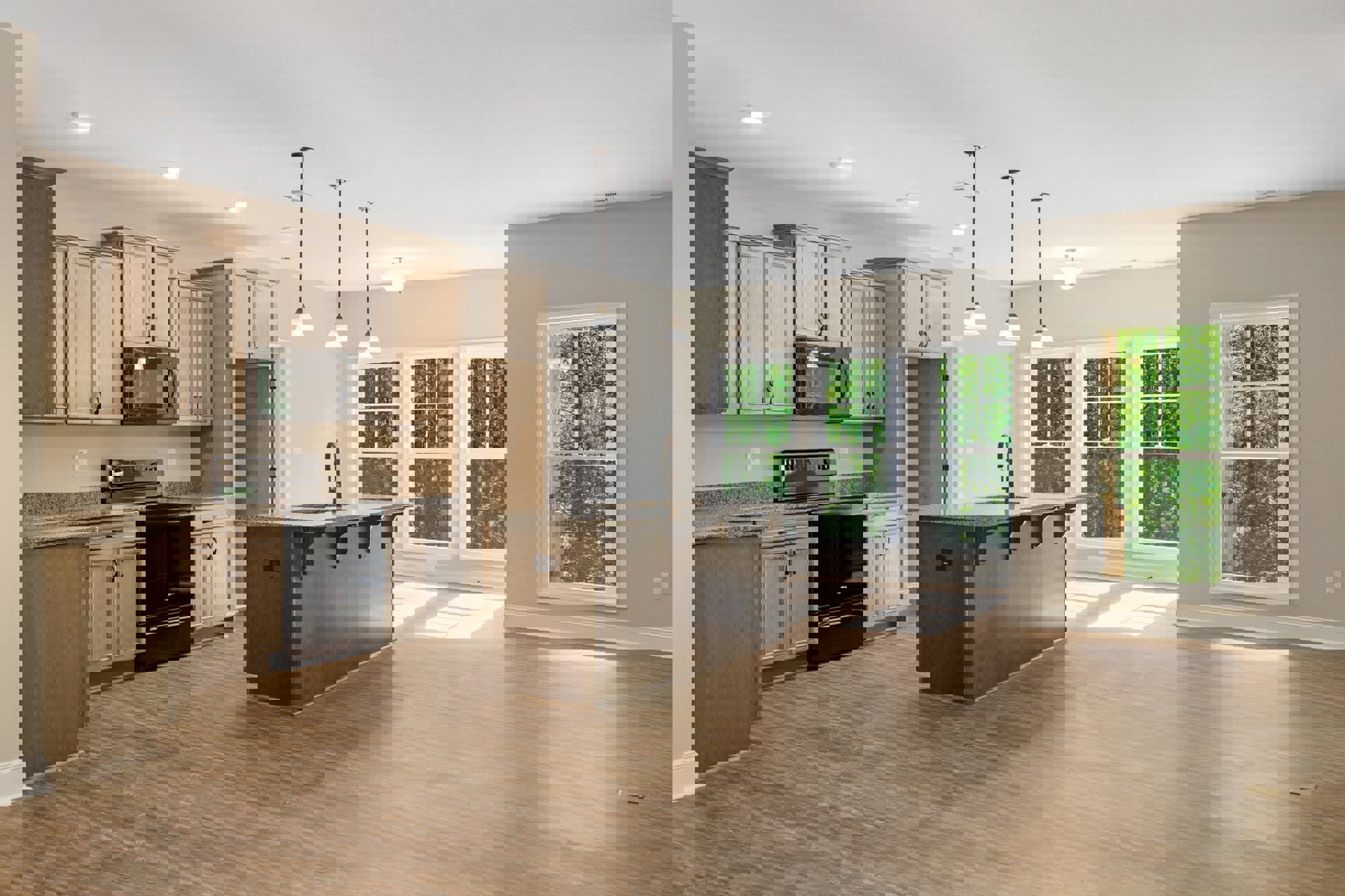 Kitchen with wood flooring, white cabinetry, black stove and oven, built-in microwave, stone countertop with stainless steel sink, window overlooking trees, wooden desk in adjacent