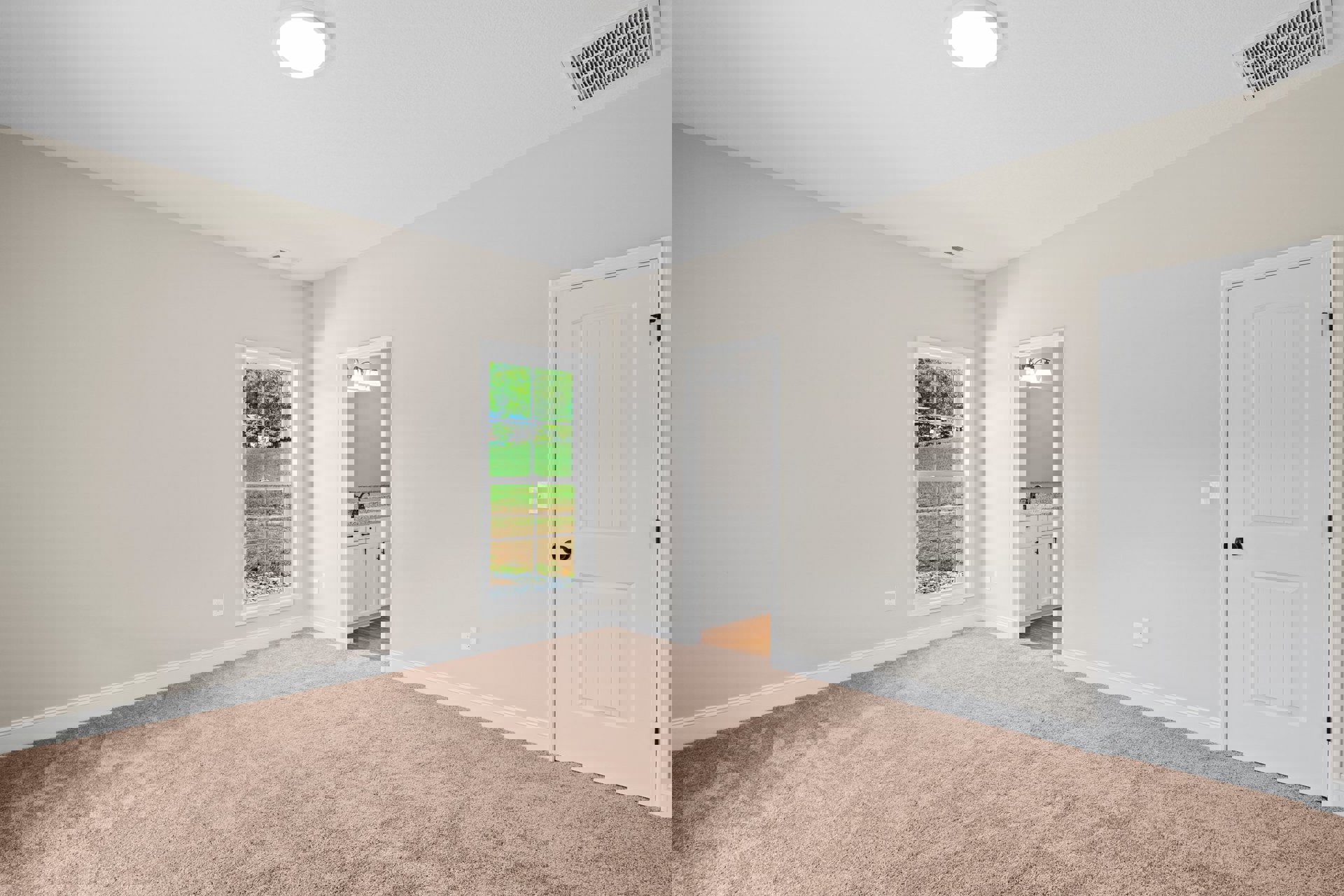 Beige carpeted floor, white walls, white door with black knob, window overlooking grassy field, ceiling light fixture, ceiling vent