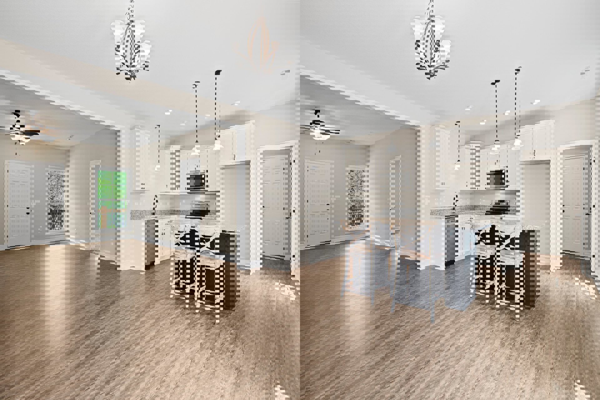 Open kitchen and dining area with wood flooring, white cabinetry, black hardware, built-in microwave, modern light fixture with white shades, and white dining chairs around a