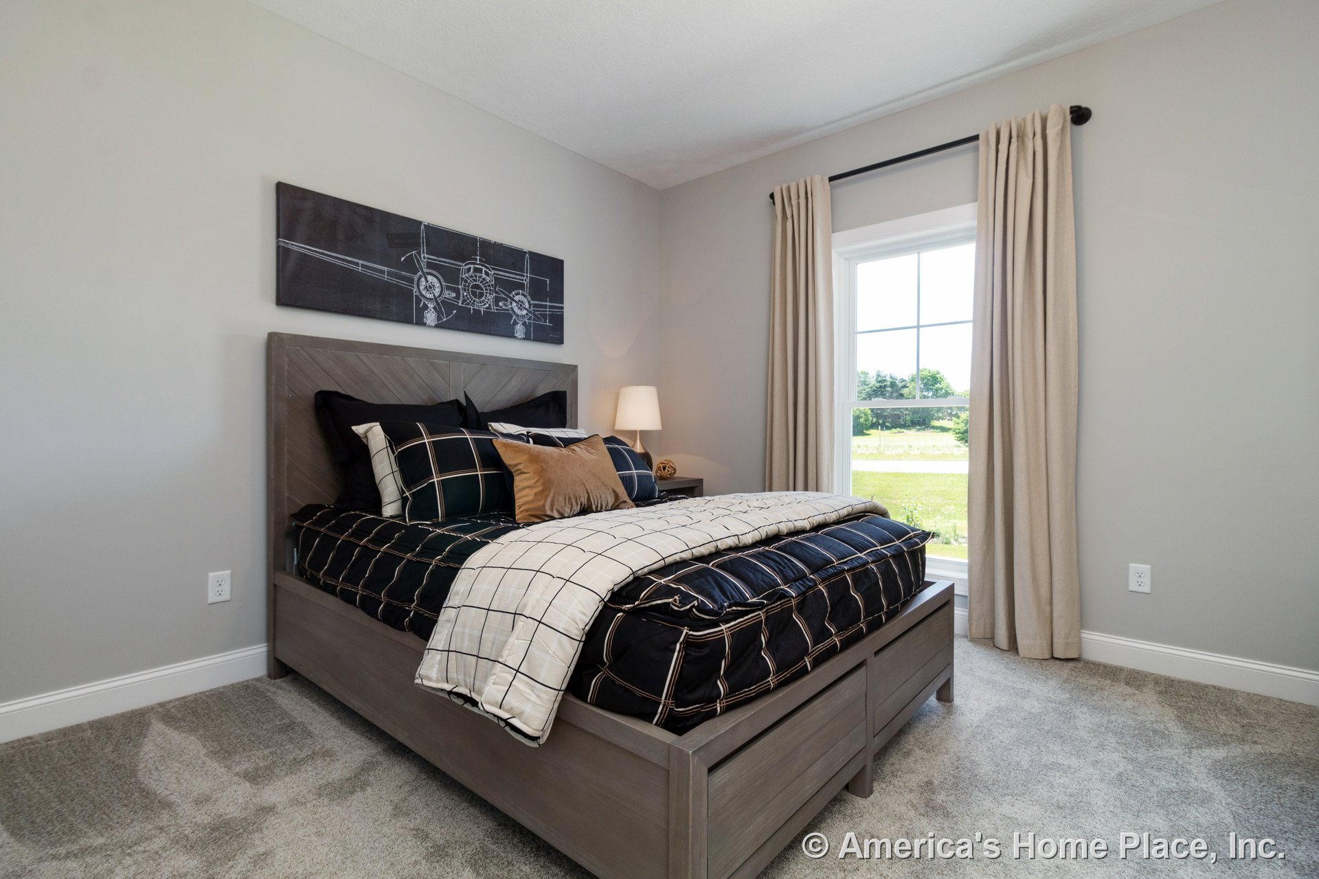 Bedroom with large grid-pattern window, beige curtains, light gray carpet flooring, light gray painted walls, white baseboard trim, and flat ceiling.