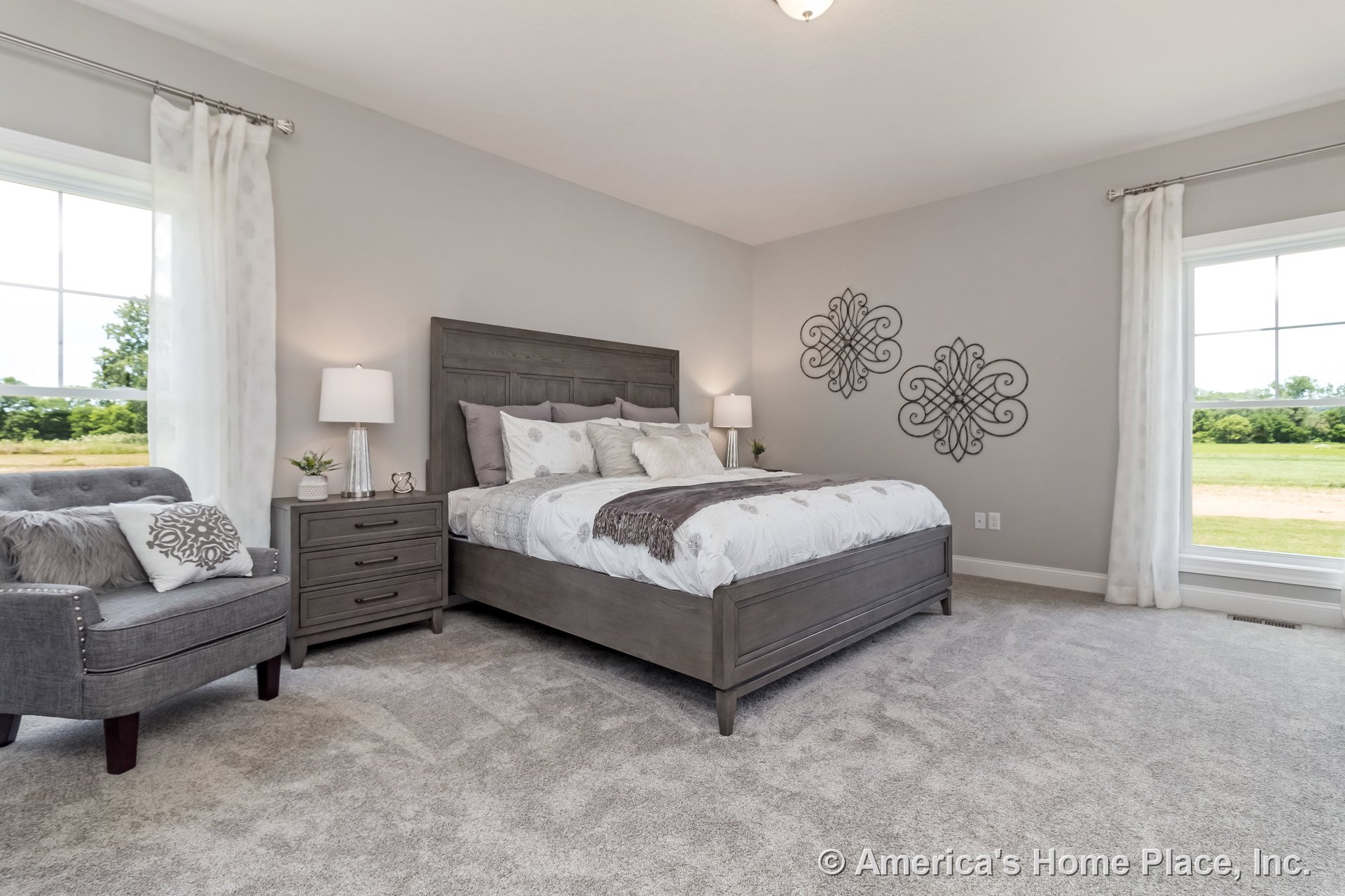 Bedroom with expansive double-pane windows, light gray carpet flooring, neutral painted walls, white ceiling featuring a flush mount light, baseboard trim, curtain rods, and sheer