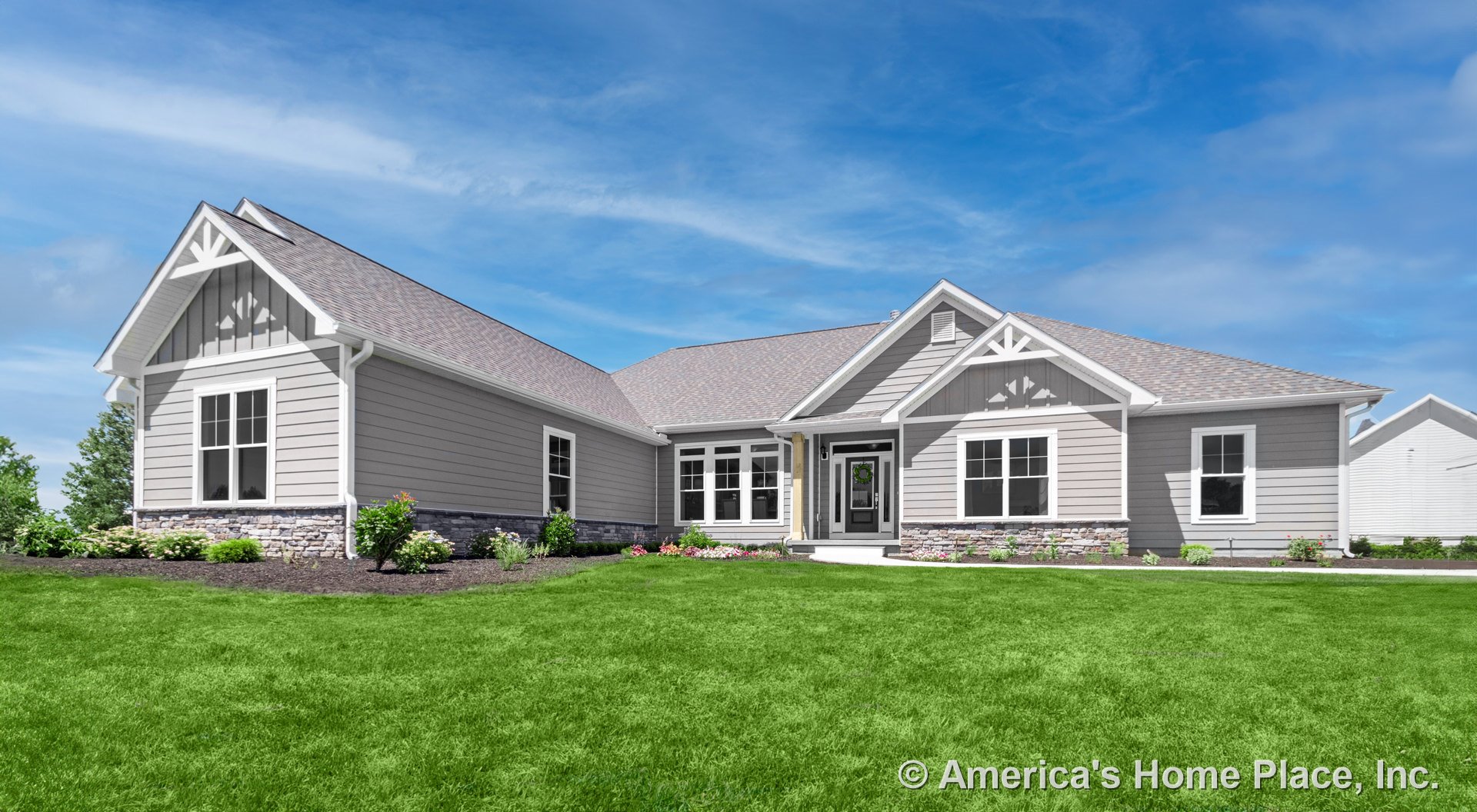 Gray horizontal siding with stone veneer foundation, front porch supported by columns, multi-pane windows, decorative gable brackets, architectural shingle roof, landscaped entry