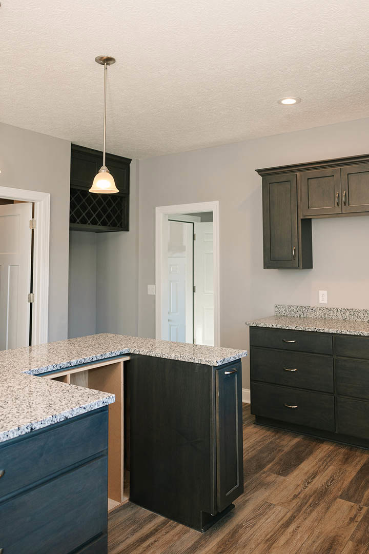 Granite countertops with white cabinetry, stainless steel appliances, and a glass-paneled door in a modern kitchen
