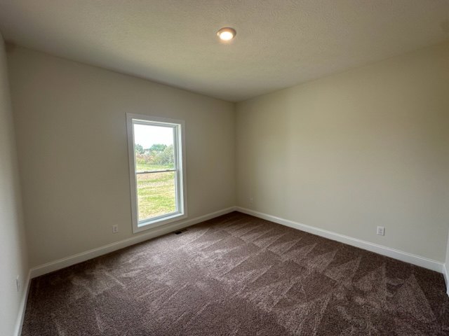 Carpeted room with white walls, large window, and smooth plaster ceiling