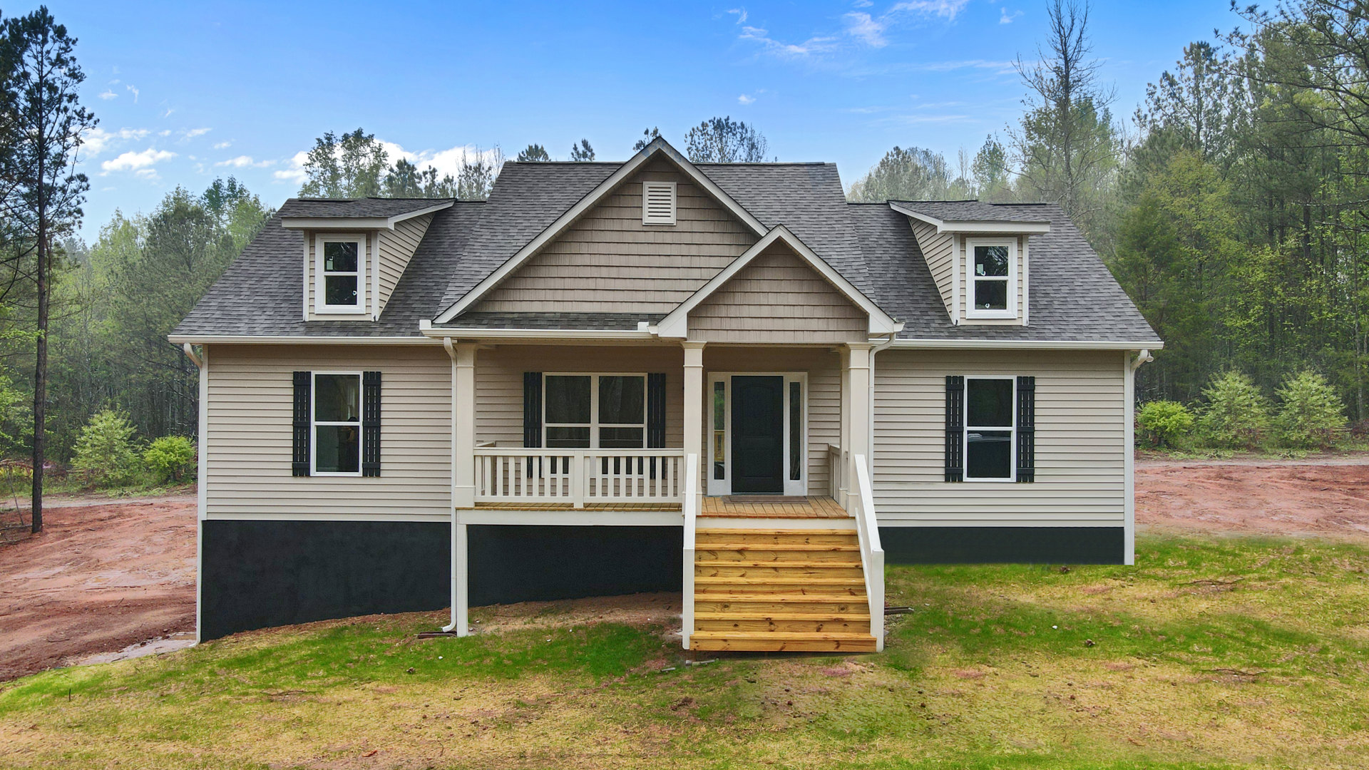 Brick exterior home with two covered porches, black door with white trim, wooden stairs, white vent, and windows including one with a person visible inside.