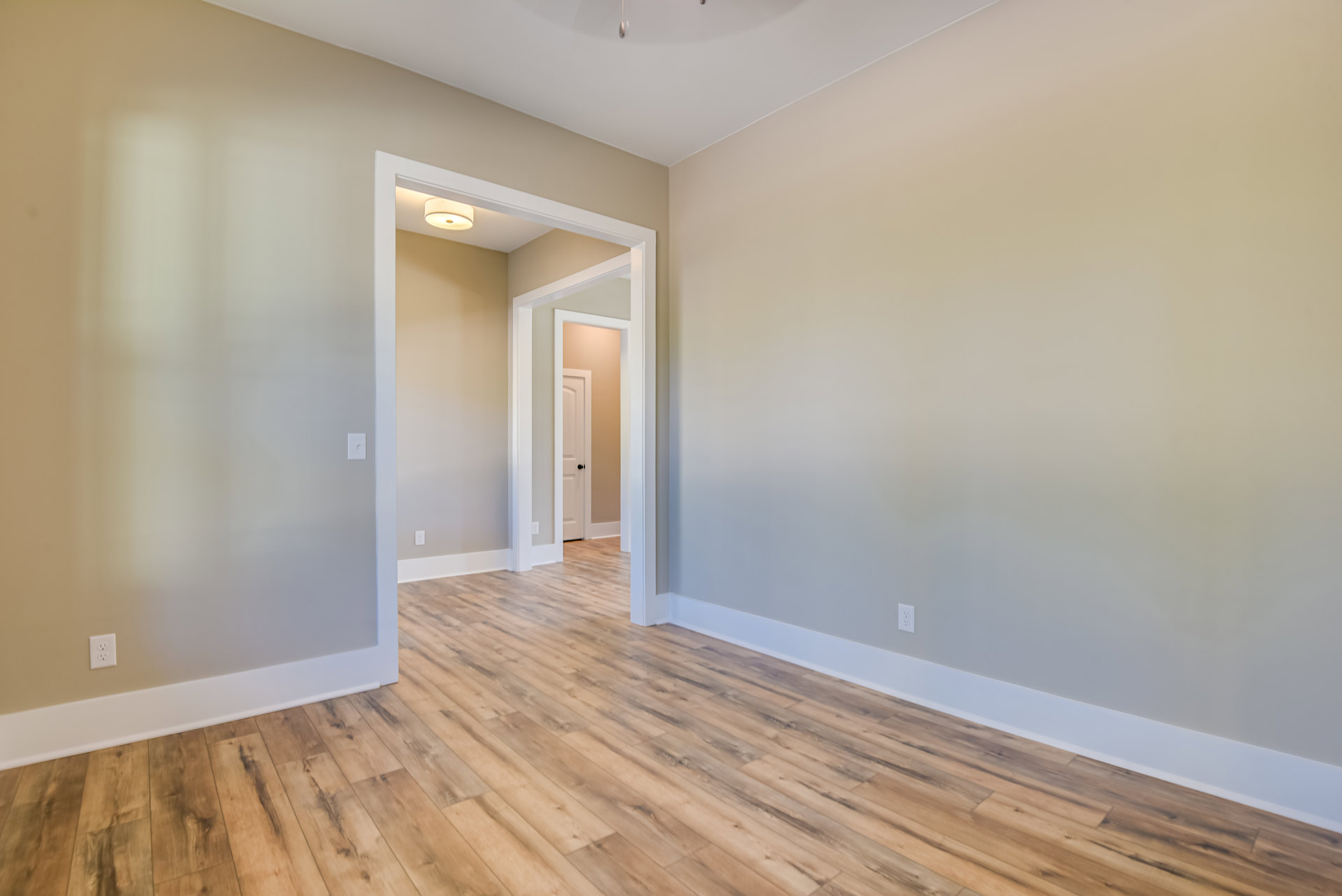 Wood floor room with white walls, white trim, and ceiling fan