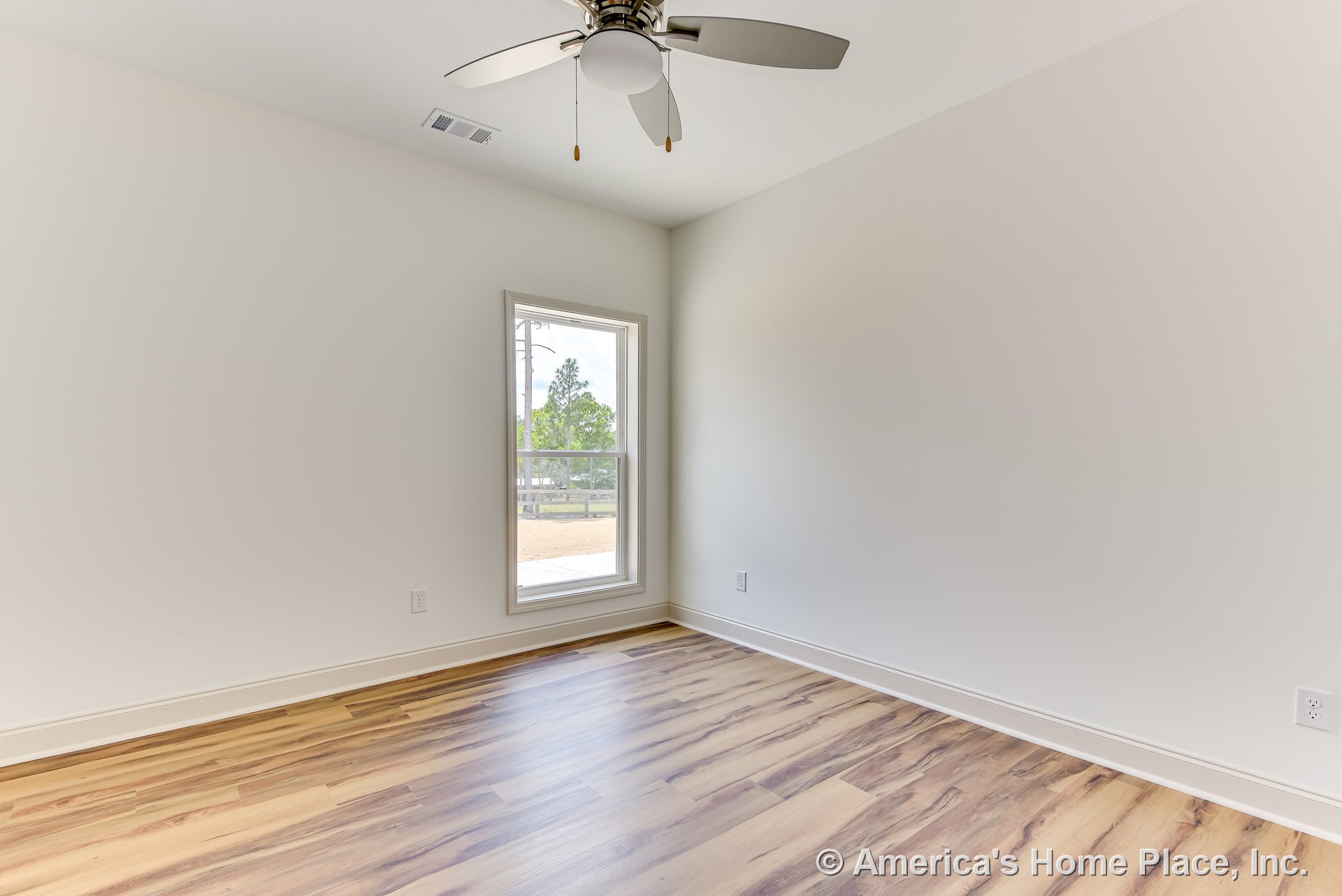 Bedroom with light wood-look plank flooring, neutral walls, white trim and baseboards, single window with white casing, ceiling fan featuring integrated light fixture, visible vent