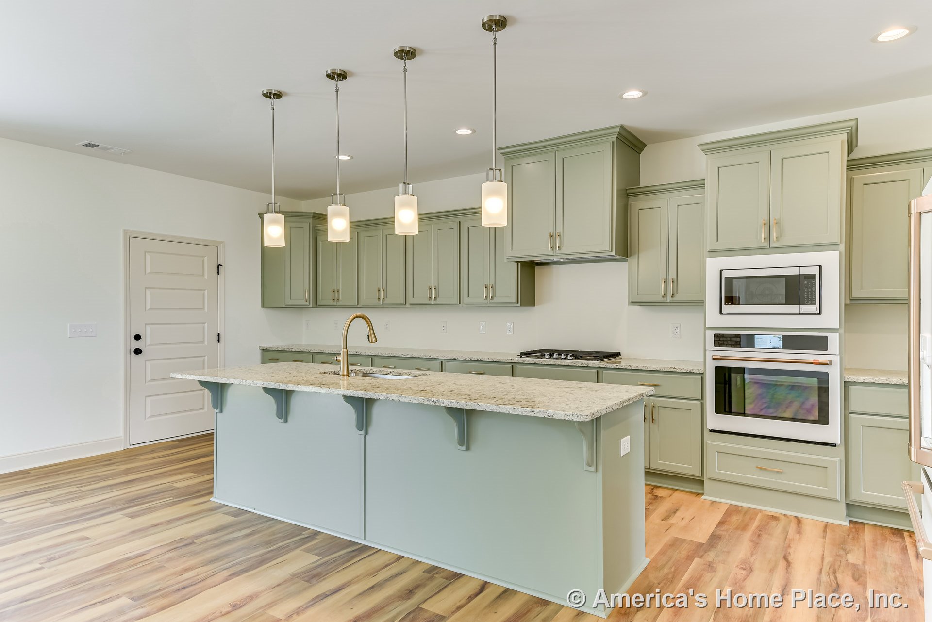 Sage green shaker cabinets, granite countertops, large kitchen island with pendant lights, double wall oven and built-in microwave, wood-look flooring, undermount sink with gold