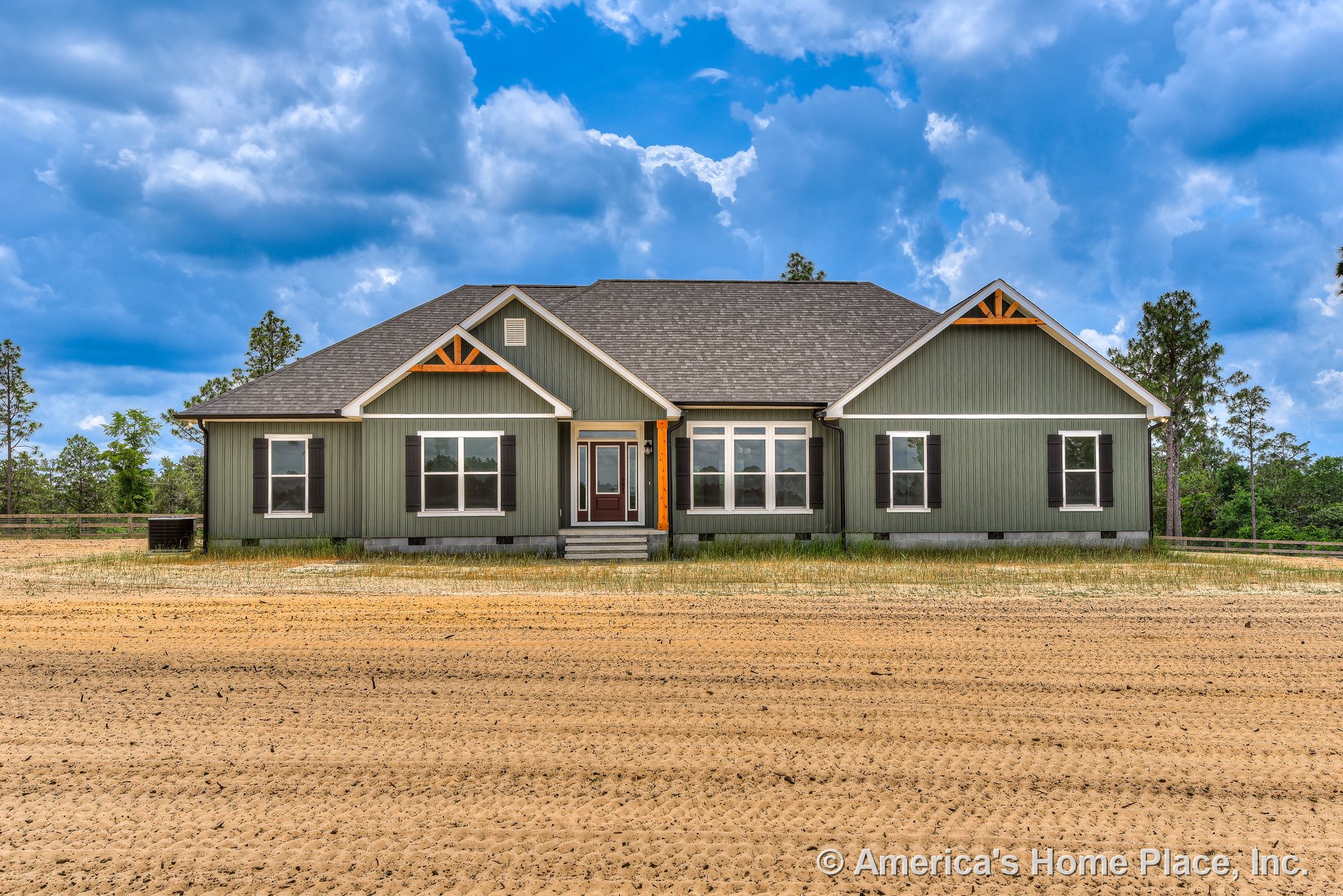 Green vertical siding with dark shutters, decorative gable trim, wood accent brackets, front porch with steps, multiple double-hung windows with detailed trim, central glass entry