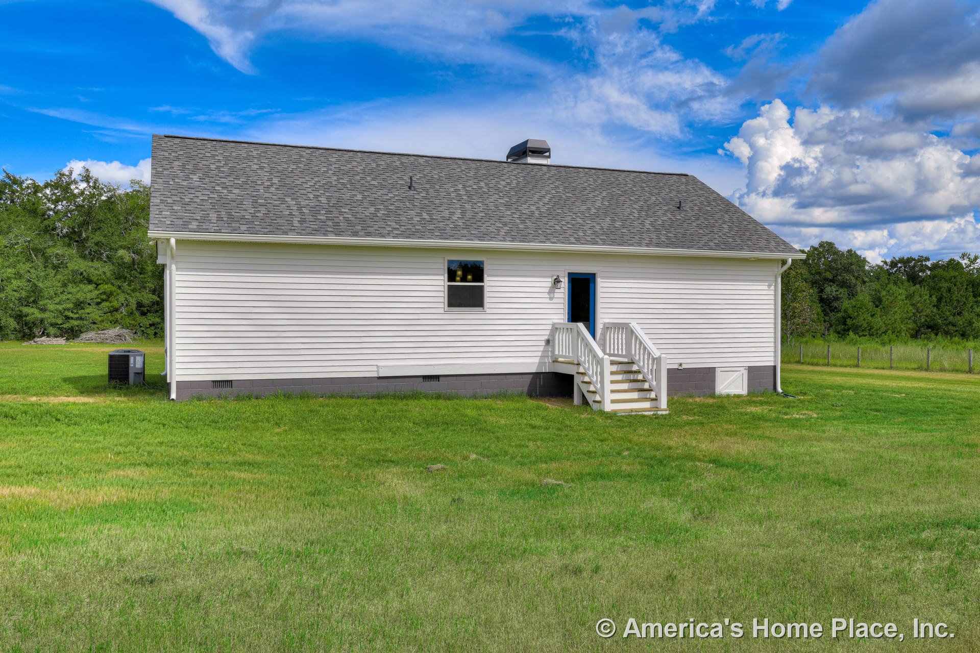 White horizontal vinyl siding, gray shingle roof, small entry porch with railing and stairs, single exterior door, concrete block foundation, central air conditioning unit, white
