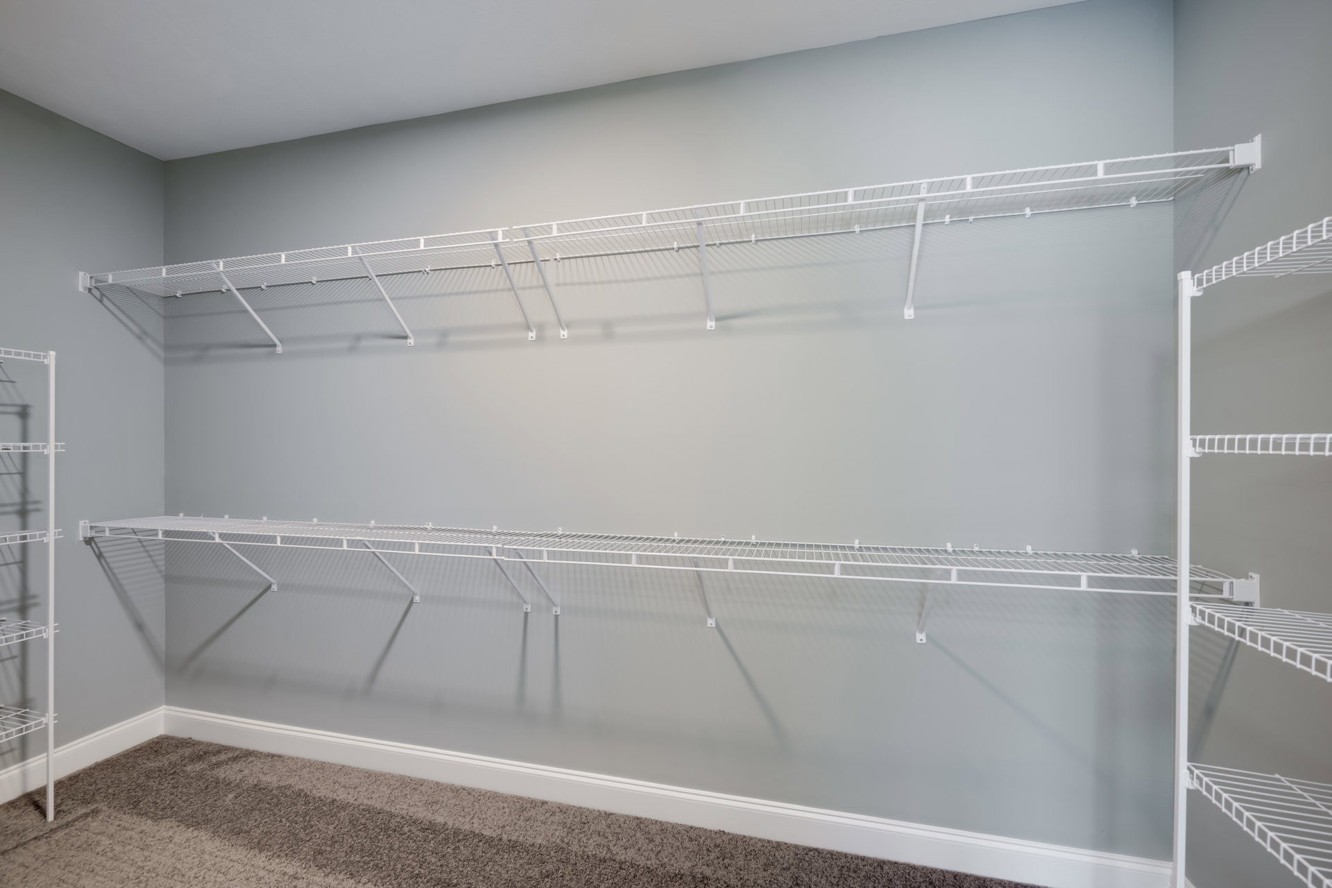 White wire shelf mounted on a light-colored wall in a modern interior room