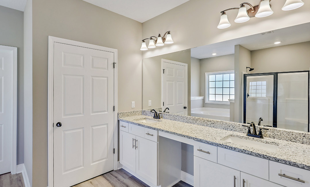 Bathroom featuring a marble countertop, expansive mirror above vanity, white cabinetry with black hardware, double glass doors, square window, and modern light fixture