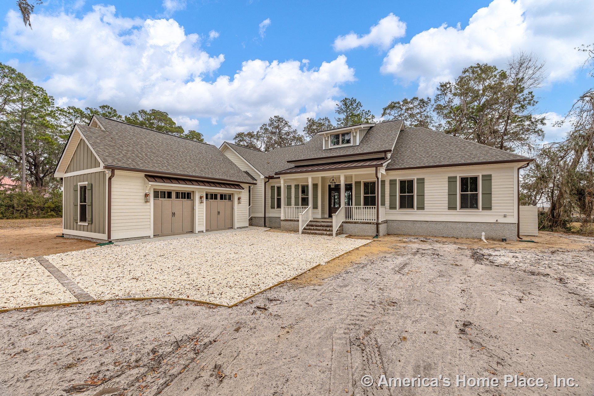 Covered front porch with steps, three-car garage doors, horizontal lap siding, contrasting window shutters, gable roof with dormer, gravel driveway, exterior trim, and porch