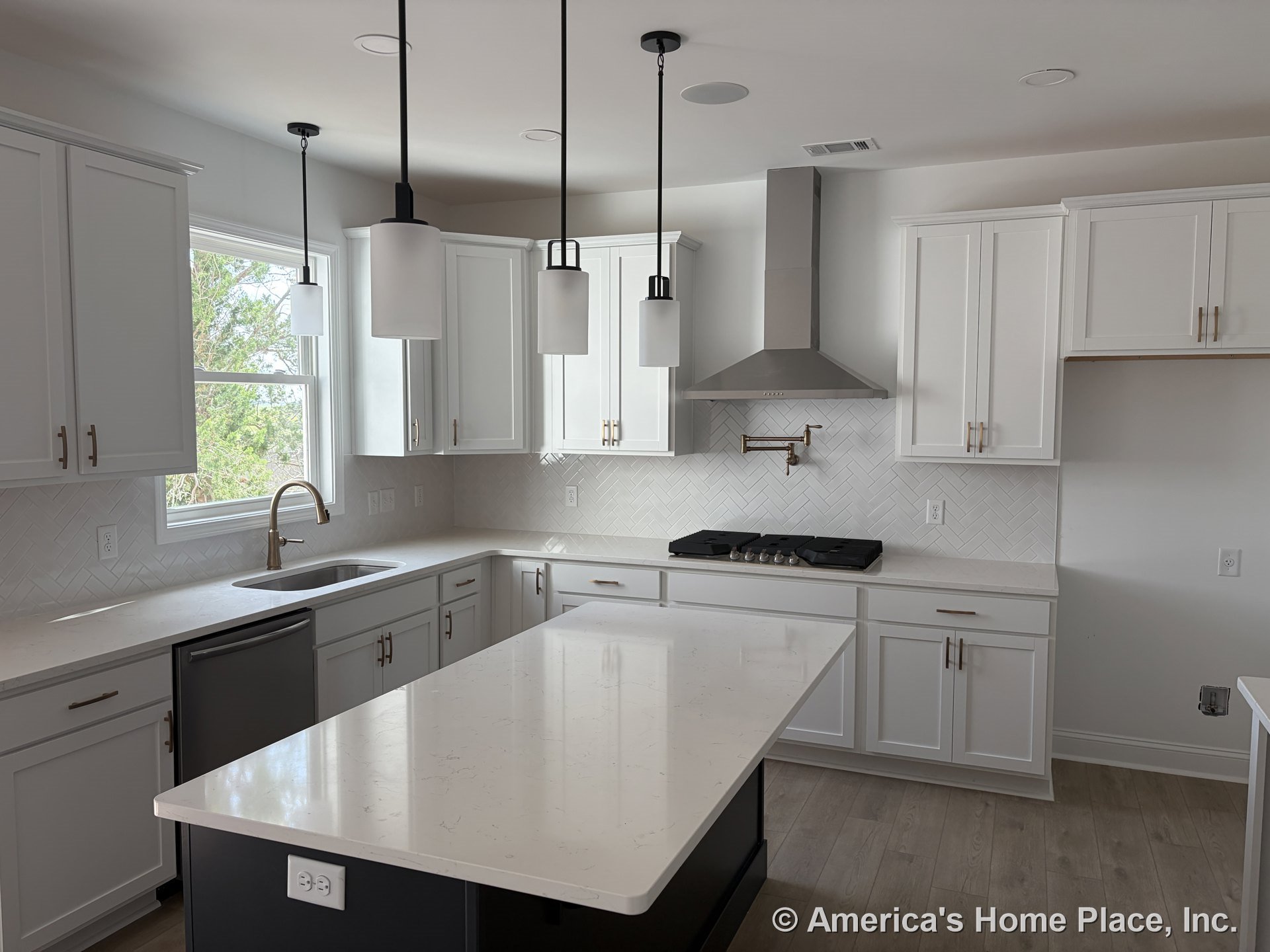 White shaker cabinets, quartz countertops, herringbone tile backsplash, stainless steel range hood, pendant lights above the island, undermount sink beneath a window, wood-look