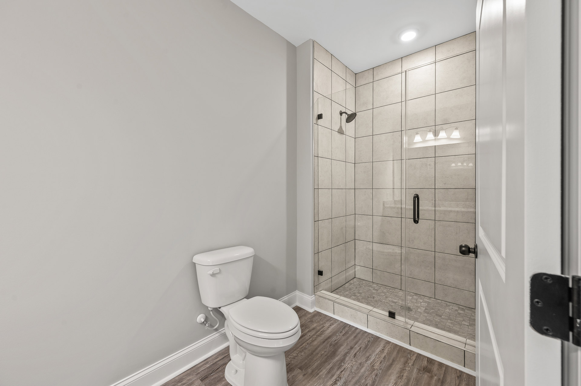 A bathroom with a toilet and shower.