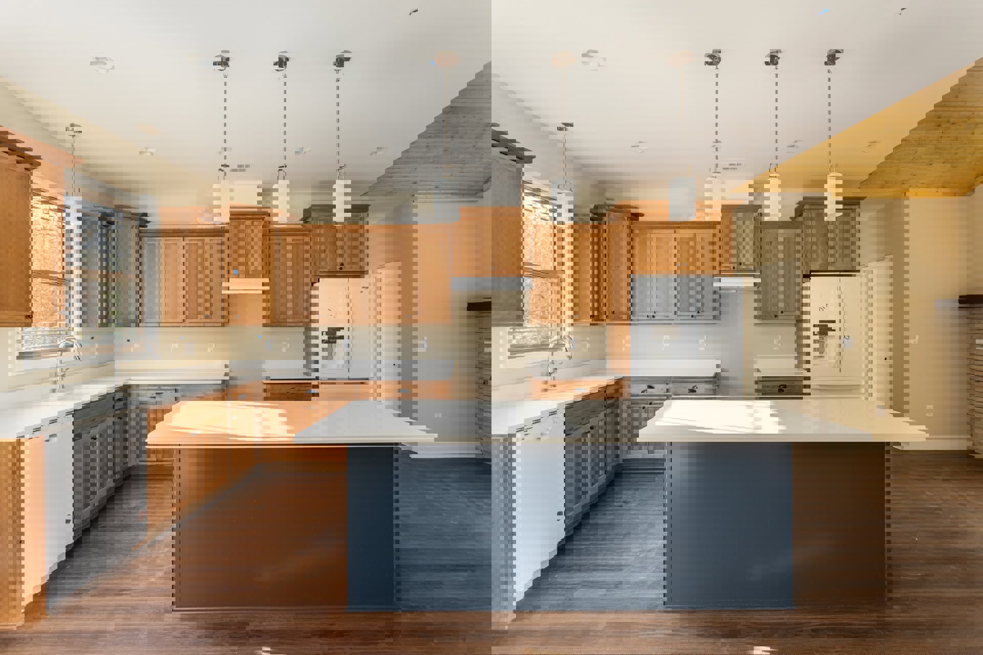 Spacious kitchen featuring a large blue-surfaced island, wooden cabinets, white countertops, and a white refrigerator with black and white writing.