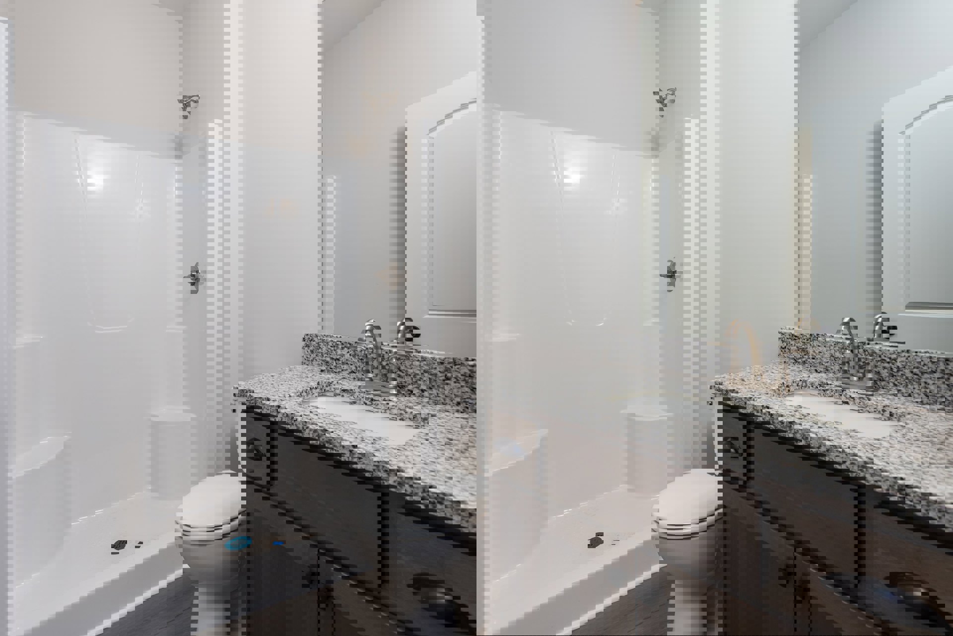 Bathroom with white tile walls, white toilet with closed lid, white sink set in a light-colored countertop, and white cabinetry below.