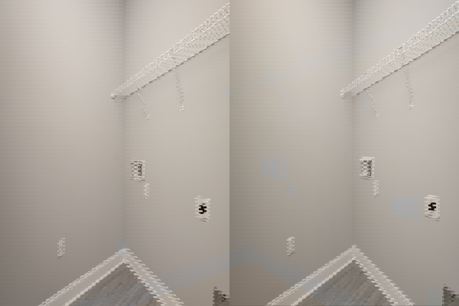 White metal wall-mounted shelf above wood floor and white wall trim, close-up of black and white electrical outlet, plaster ceiling visible.
