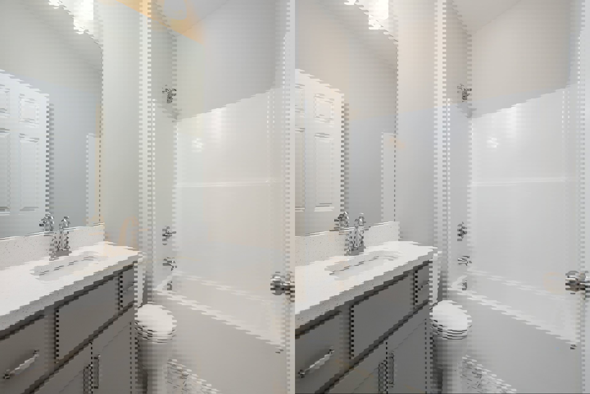 Modern bathroom with white tile walls, built-in bathtub, white toilet, chrome faucet, and light wood vanity with stone countertop