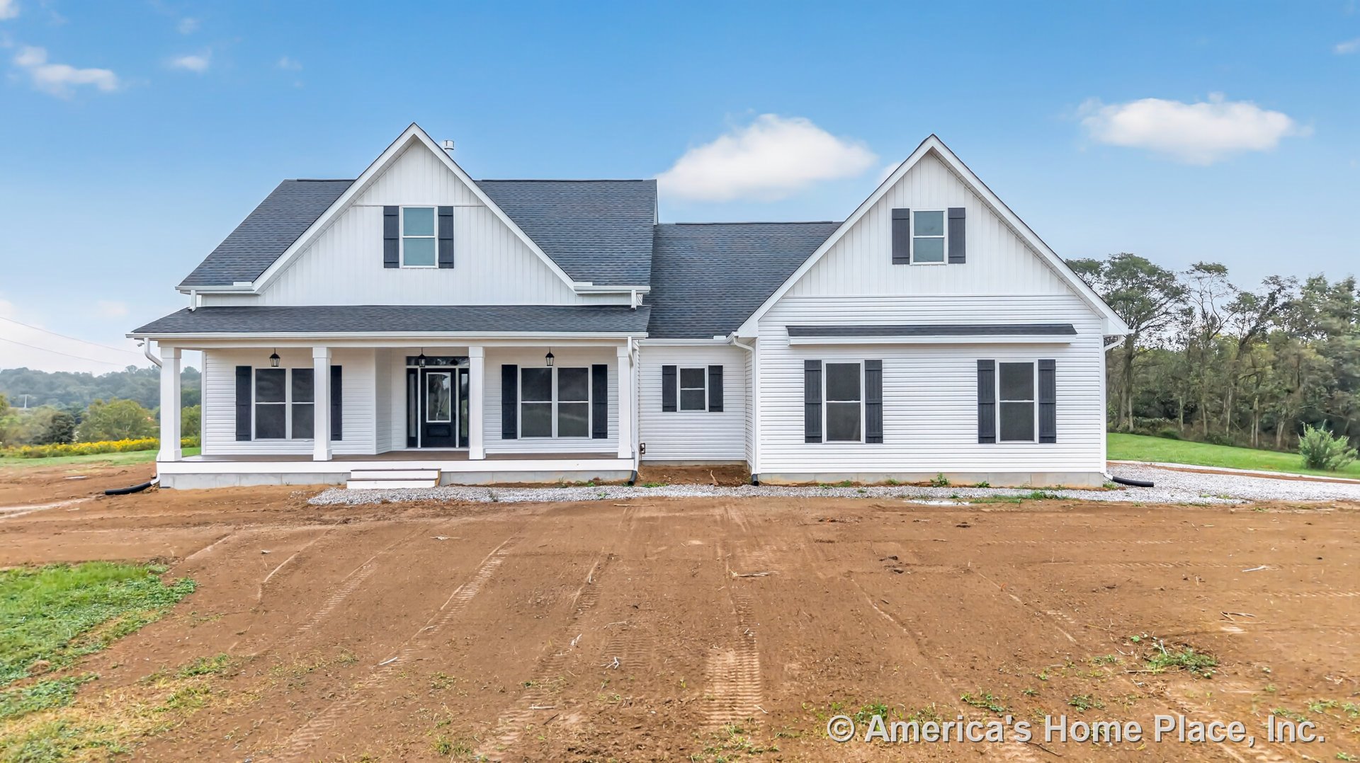 White horizontal siding and black window shutters on a custom home exterior with a covered front porch supported by columns, glass-paneled front entry door, gabled roof with