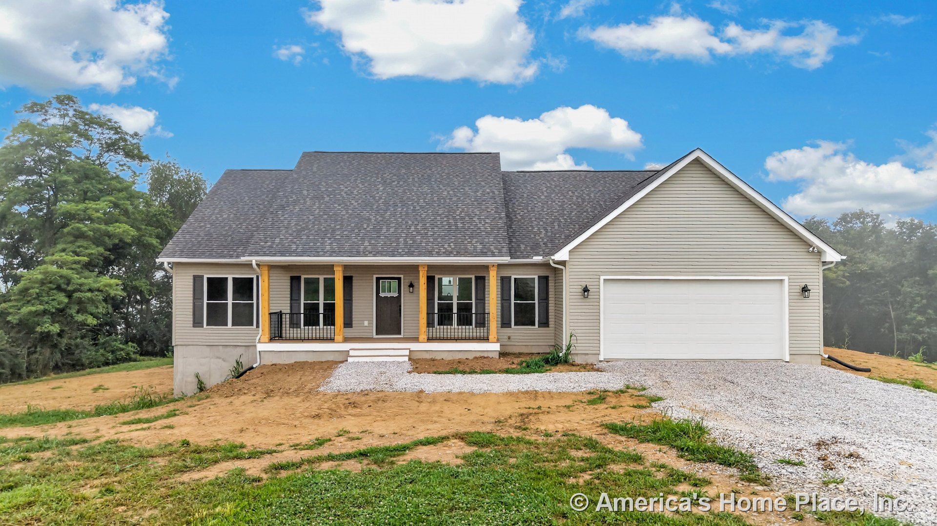 Covered front porch with wood columns, gray vinyl siding exterior, black window shutters, white two-car garage door, gravel driveway, dark shingle roof, white trim, outdoor