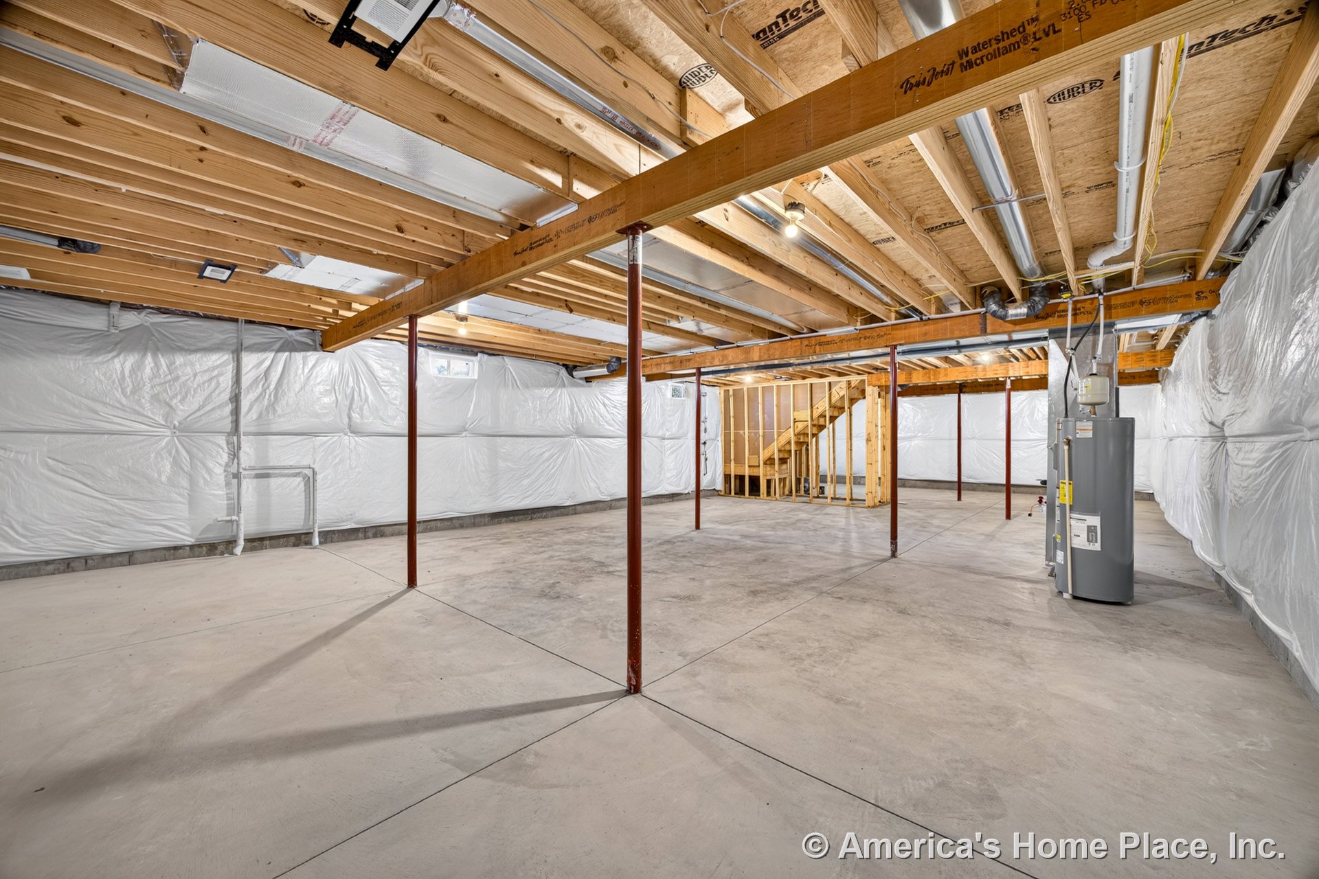 Unfinished basement with exposed wood ceiling joists, concrete slab floor, plastic-wrapped walls, metal support columns, utility water heater, open mechanical systems, and