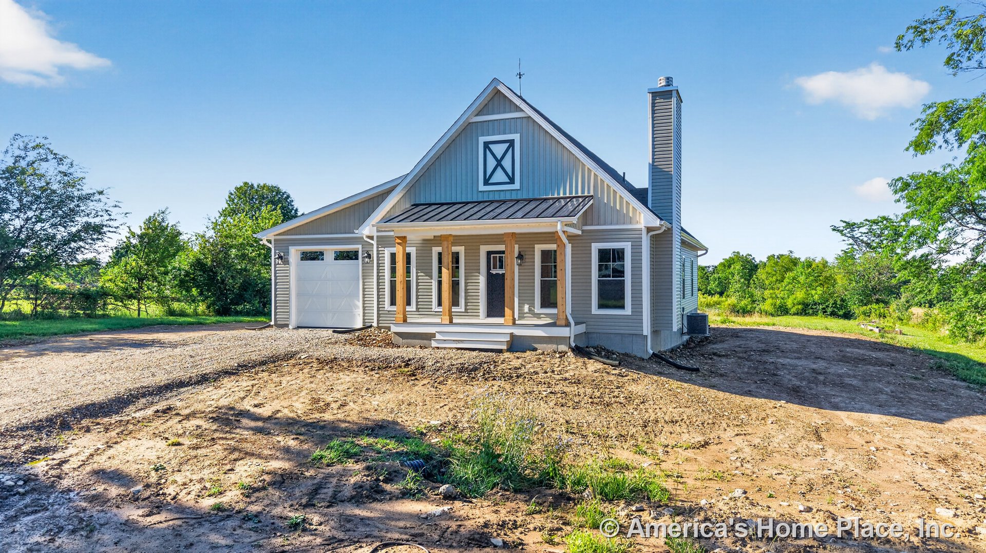 Covered front porch with wood columns, vertical board siding, metal porch roof, white trim windows, attached single-car garage door, exterior chimney, and entry steps.