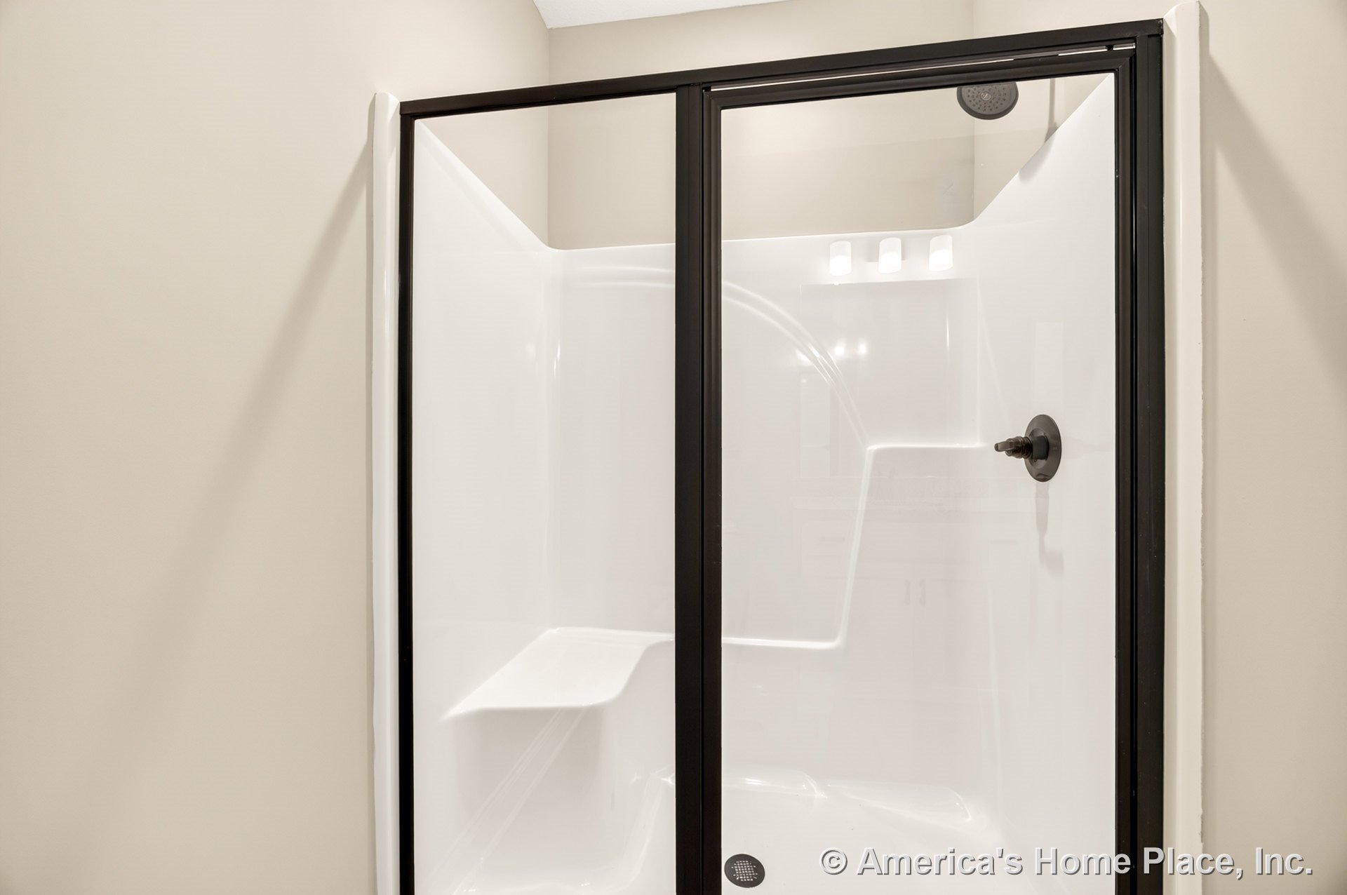 Master bathroom with a modern walk-in shower featuring black-framed glass doors, a built-in shower seat, white acrylic walls, wall-mounted showerhead, and integrated shower