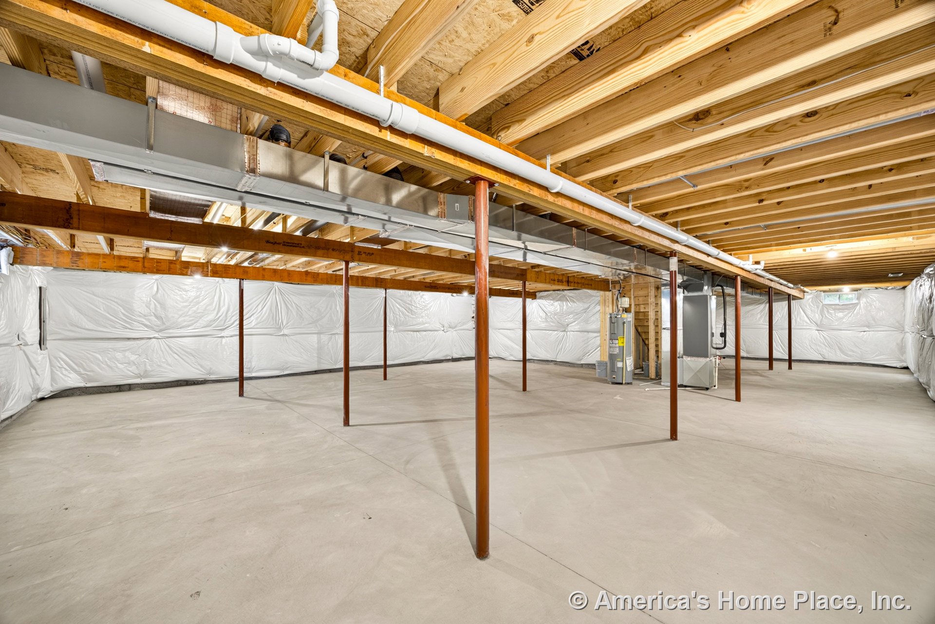 Unfinished basement with exposed wood ceiling joists, steel support columns, concrete slab flooring, wrapped foundation walls, visible ductwork, and utility area housing furnace
