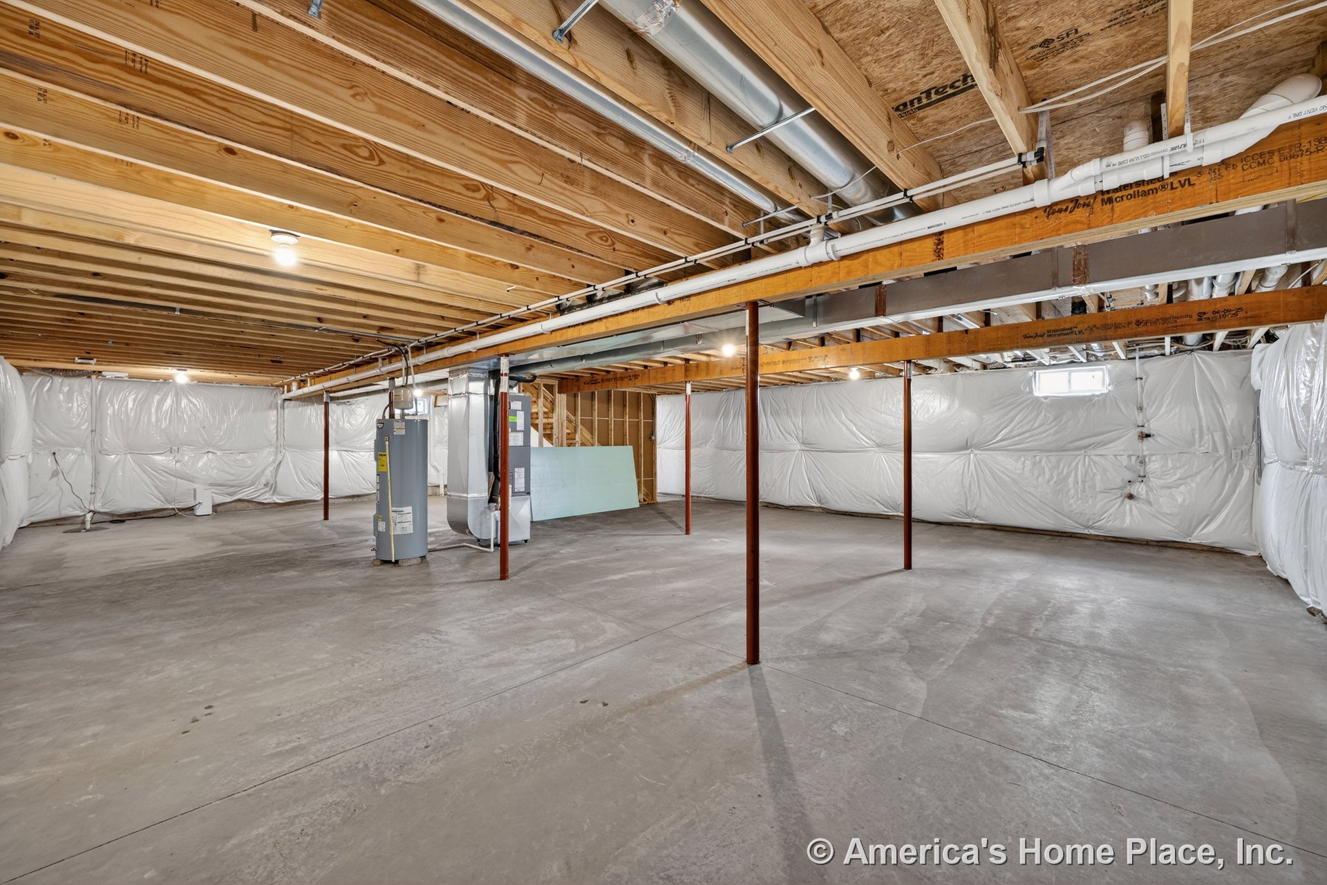 Unfinished basement with exposed wood ceiling joists, concrete slab floor, insulated plastic-wrapped walls, metal support columns, visible ductwork and piping, HVAC and water