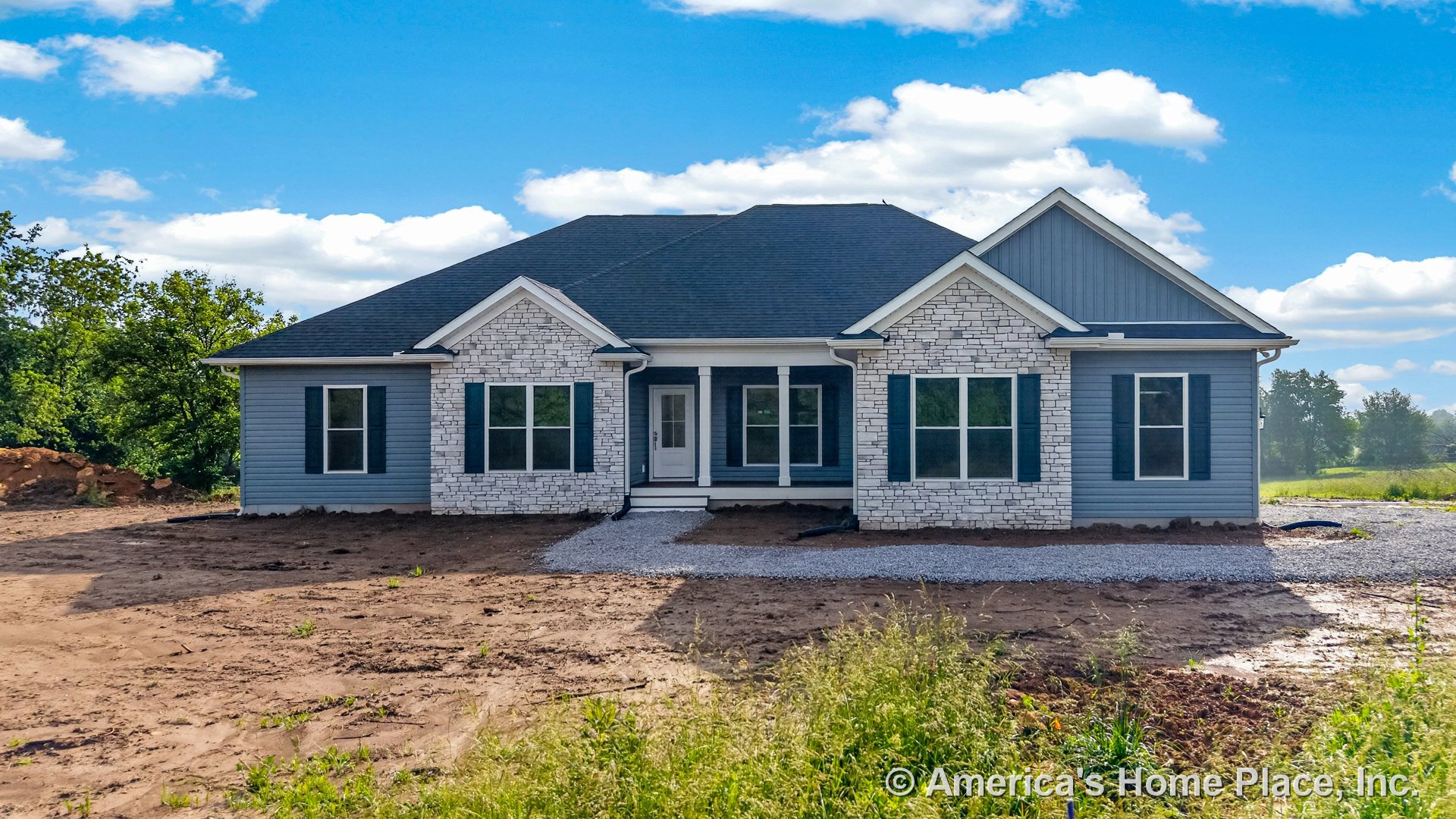 Stone veneer and horizontal siding exterior with covered front porch, double white columns, large front windows, white trim, and prominent front door.