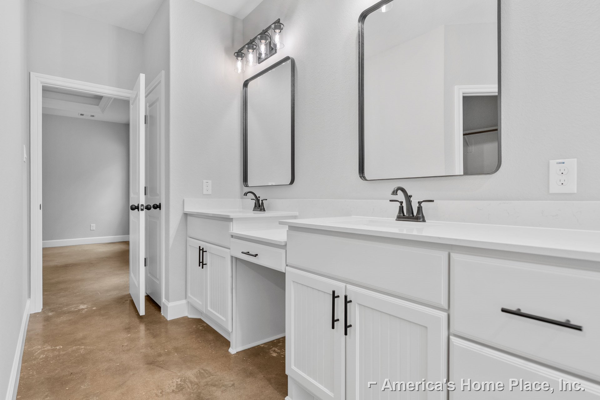 Bathroom featuring white shaker cabinets, dual wall mirrors above a quartz countertop, chrome faucets, clear glass bulb light fixture, and light gray tile flooring.