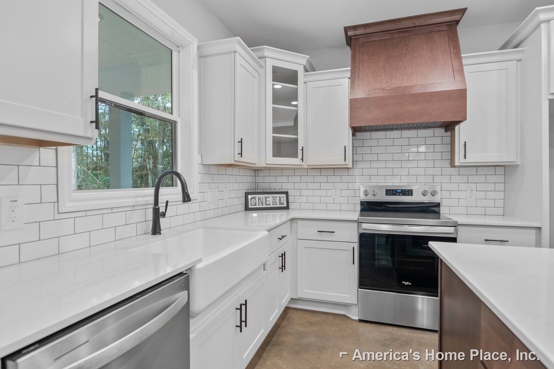 White kitchen with shaker cabinets, subway tile backsplash, stainless steel stove, undermount sink, and quartz countertops