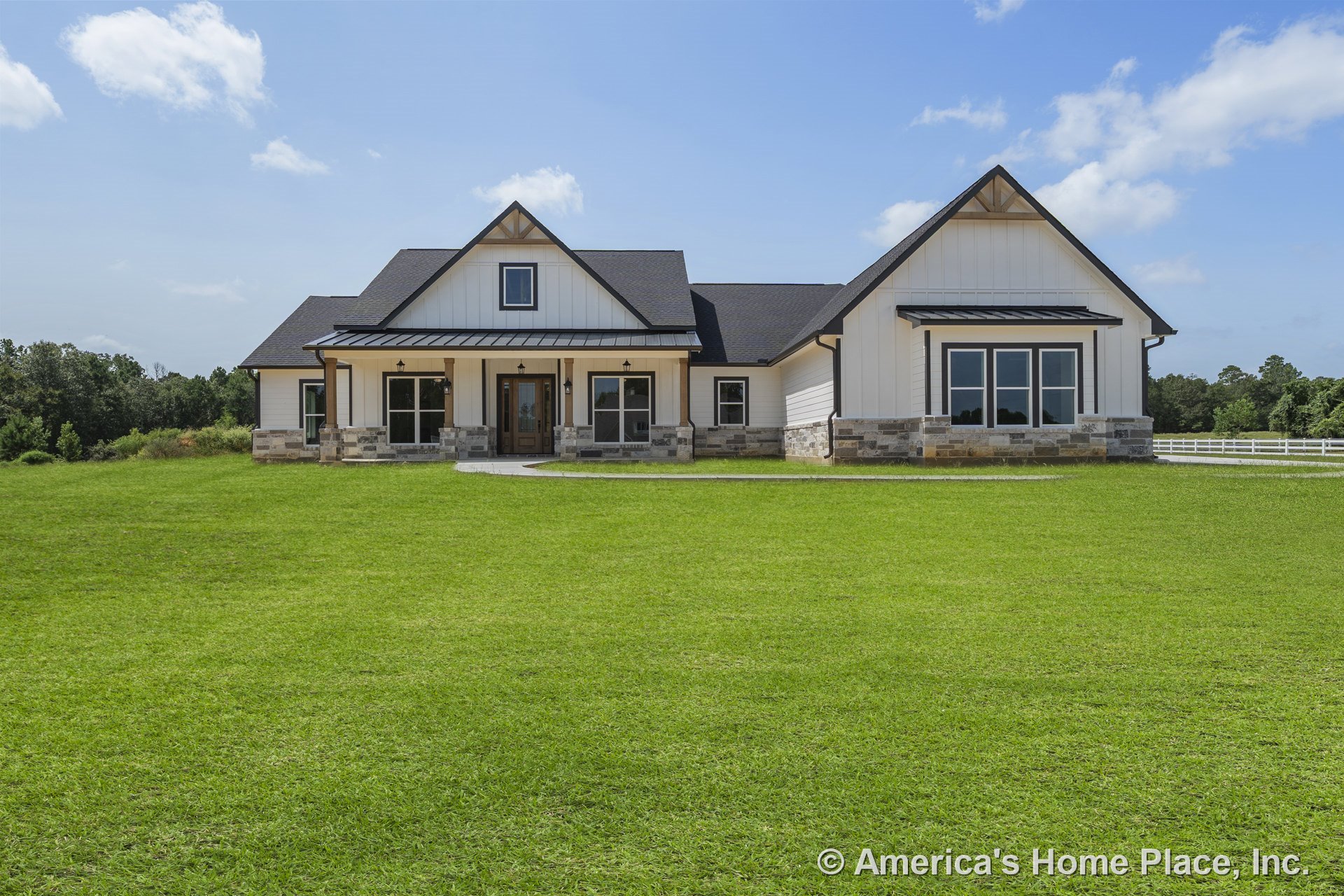 White board and batten siding with stone wainscoting, covered front porch supported by columns, multiple large windows, dark shingle roof, wood trim accents, farmhouse-style front