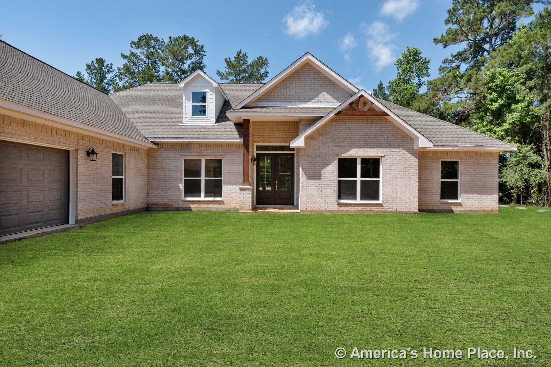 Light brick exterior with covered front porch, double entry doors, attached garage, gable roof featuring dormer window, multiple large windows, decorative trim, permanent lighting