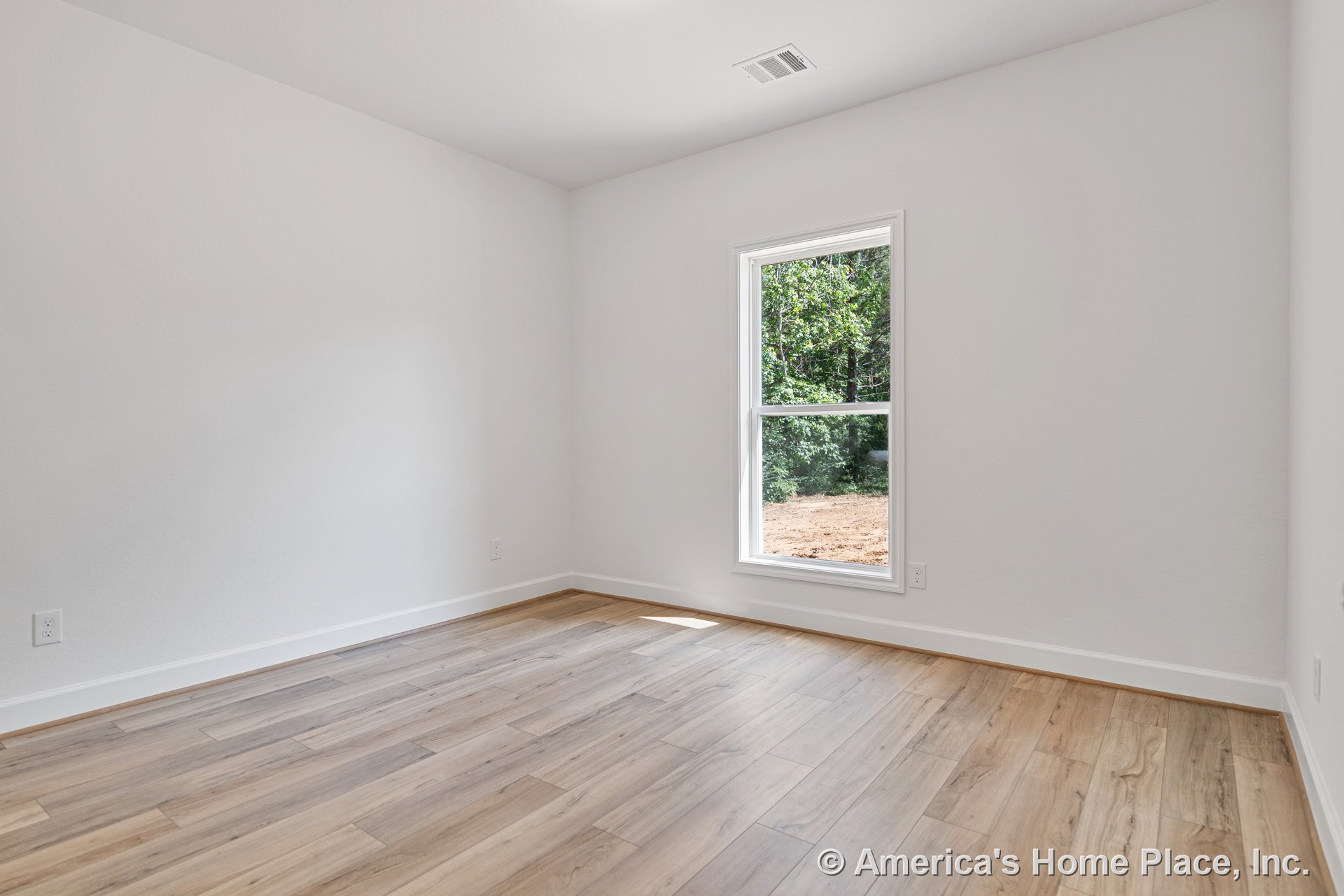 Bedroom with light wood-look plank flooring, white painted walls, large single window framed in white trim, baseboard molding, and ceiling vent.