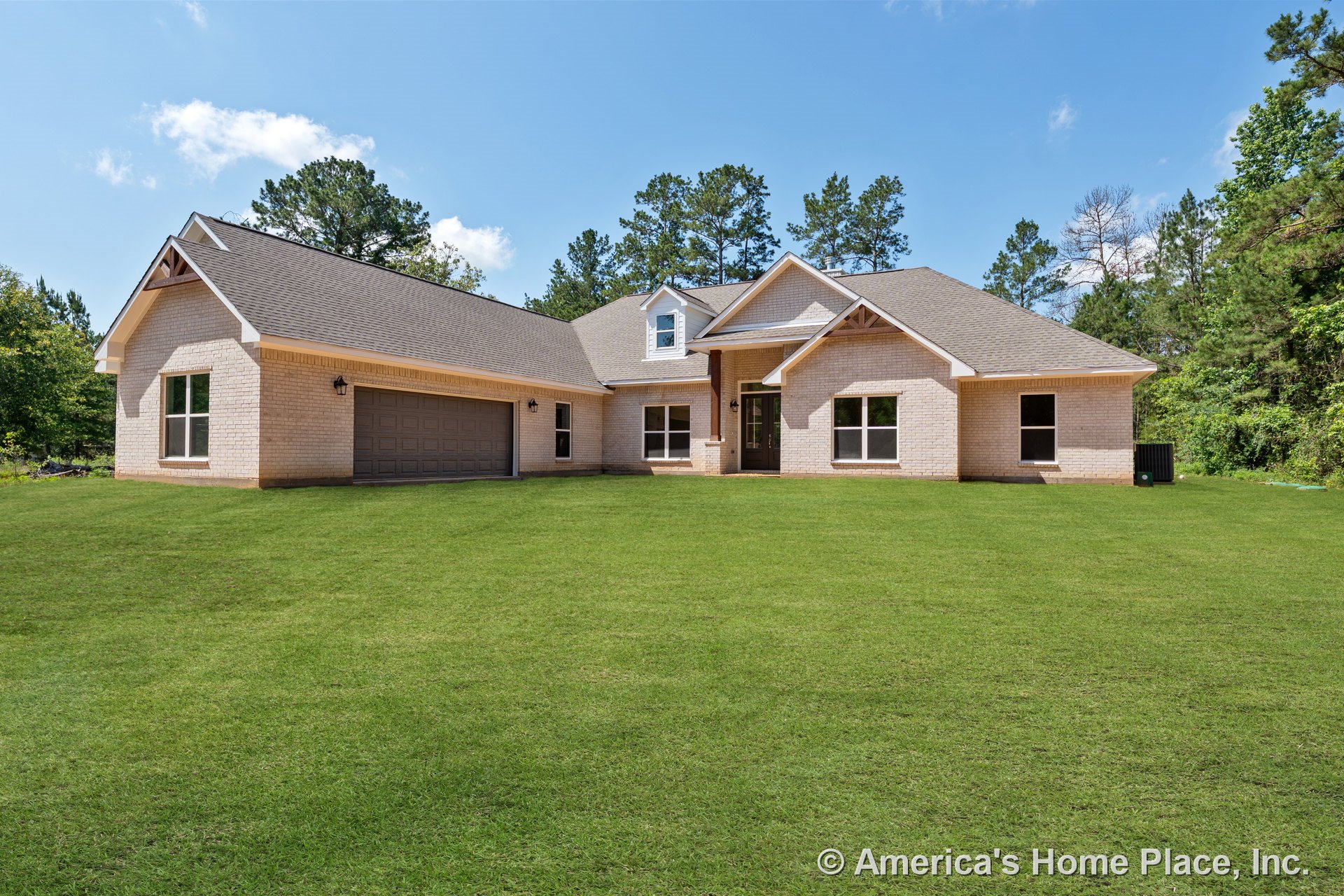 Light brick exterior with double garage doors, prominent gabled roof, large front windows, covered entry porch, trimmed roof edges, permanent lighting, roof vent, and manicured
